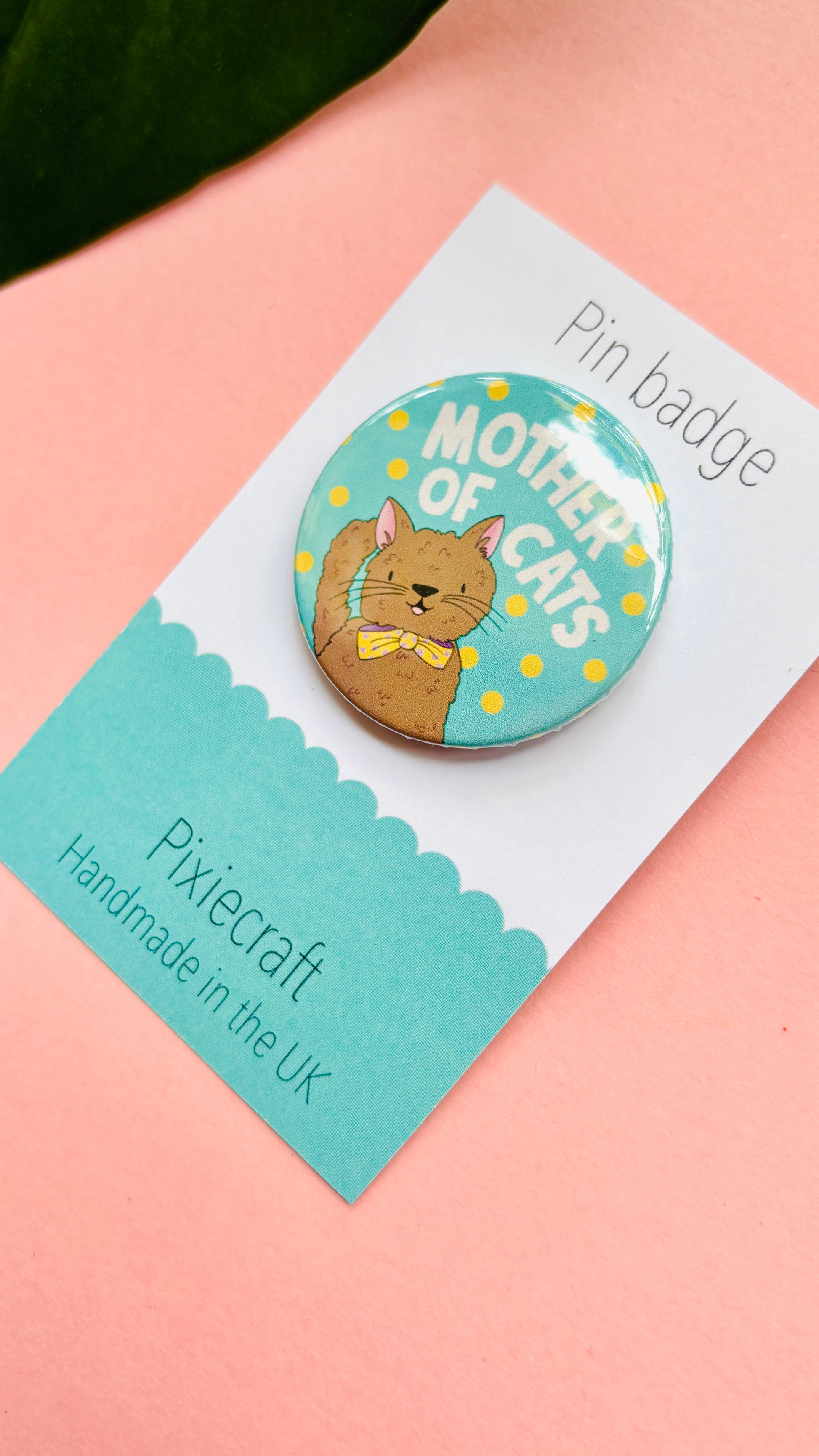 Handmade cat gift pin badge or fridge magnet. This cute accessory reads ‘mother of cats’ and you can choose from four different cat designs; brown tabby cat, orange/ginger cat, black cat, black and white cat. The hand drawn illustration is turned into a pin badge or magnet and presented on a colourful backing card ready for gifting. Great for stocking fillers.