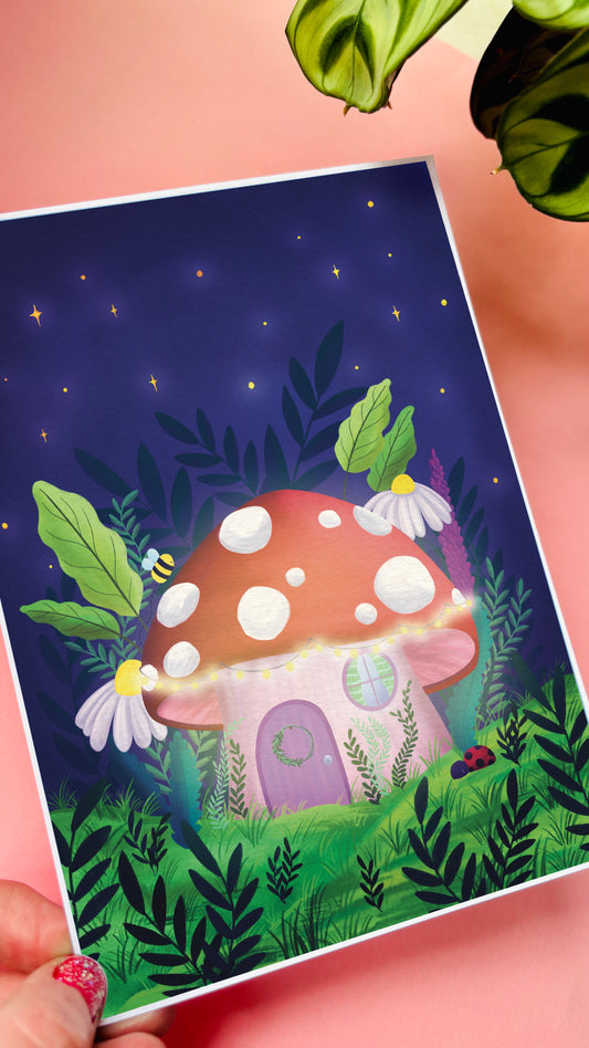 Cute wall art for kids room and fairycore decor. This adorable art print features a toadstool house hidden in the forest lit up by twinkling fairy lights under a starry sky with a magical vibe. Available in A4, A3 and 5x7 inches