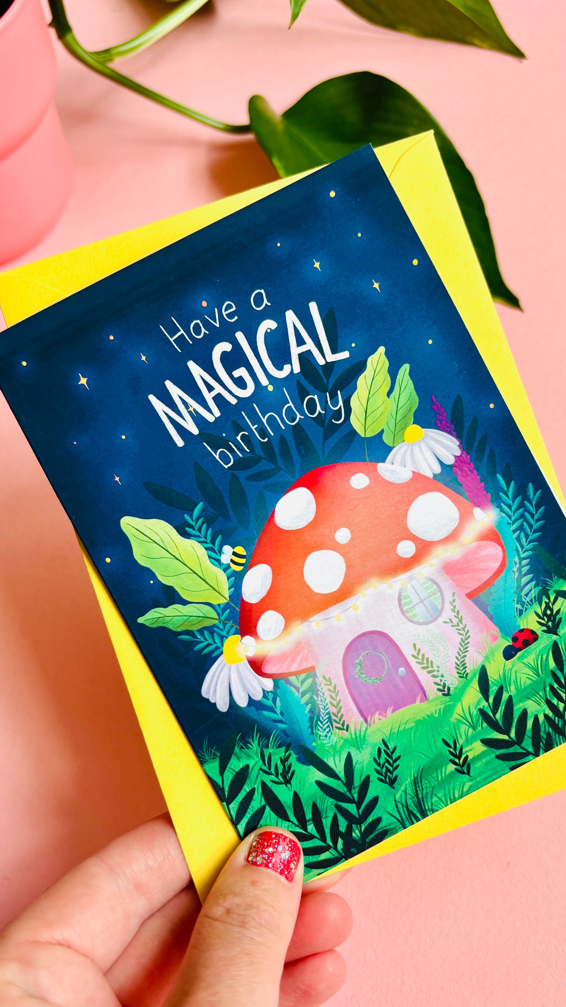 Magical handmade birthday card of a cute mushroom fairy cottage surrounded by botanical plants and flowers with a fantasy vibe reads “have a magical birthday”