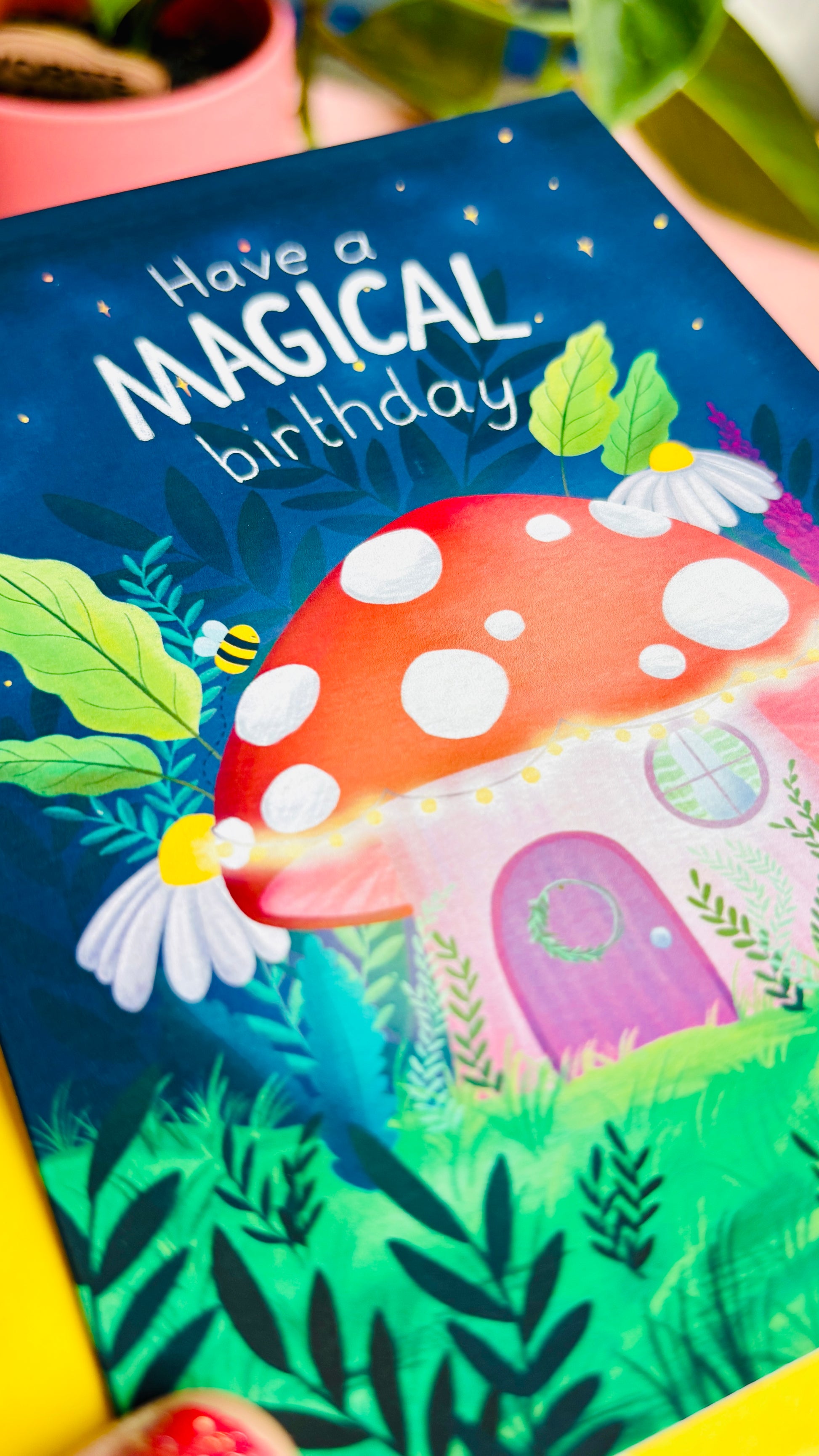 Magical handmade birthday card of a cute mushroom fairy cottage surrounded by botanical plants and flowers with a fantasy vibe reads “have a magical birthday”