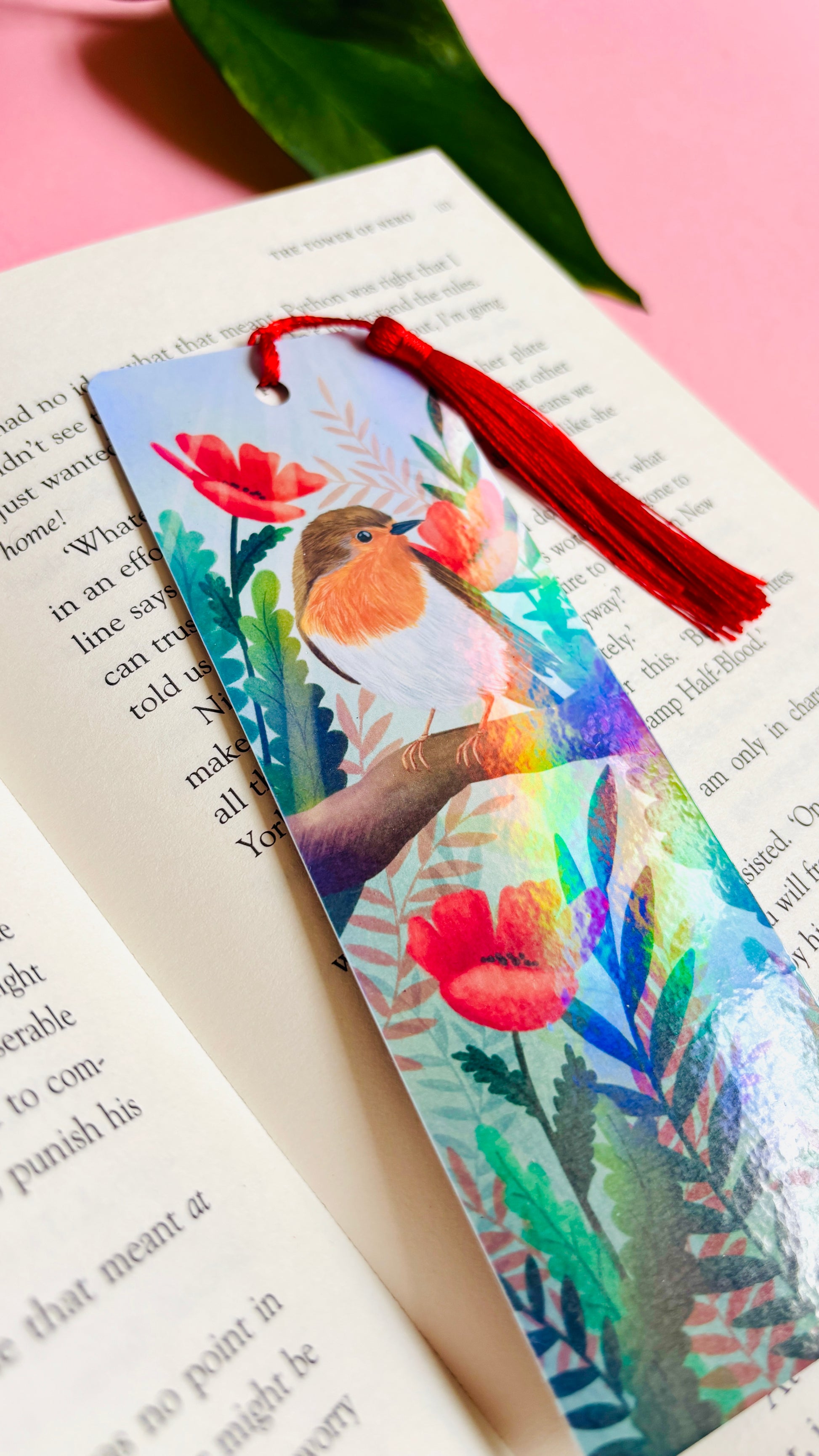 Handmade bookmark with a beautiful hand drawn illustration of a robin sitting among poppies. Finished with a rainbow holographic laminate, rounded corners and a tassel. The symbols of remembrance make this bookmark a thoughtful grief gift or way or remembering lost loved ones.