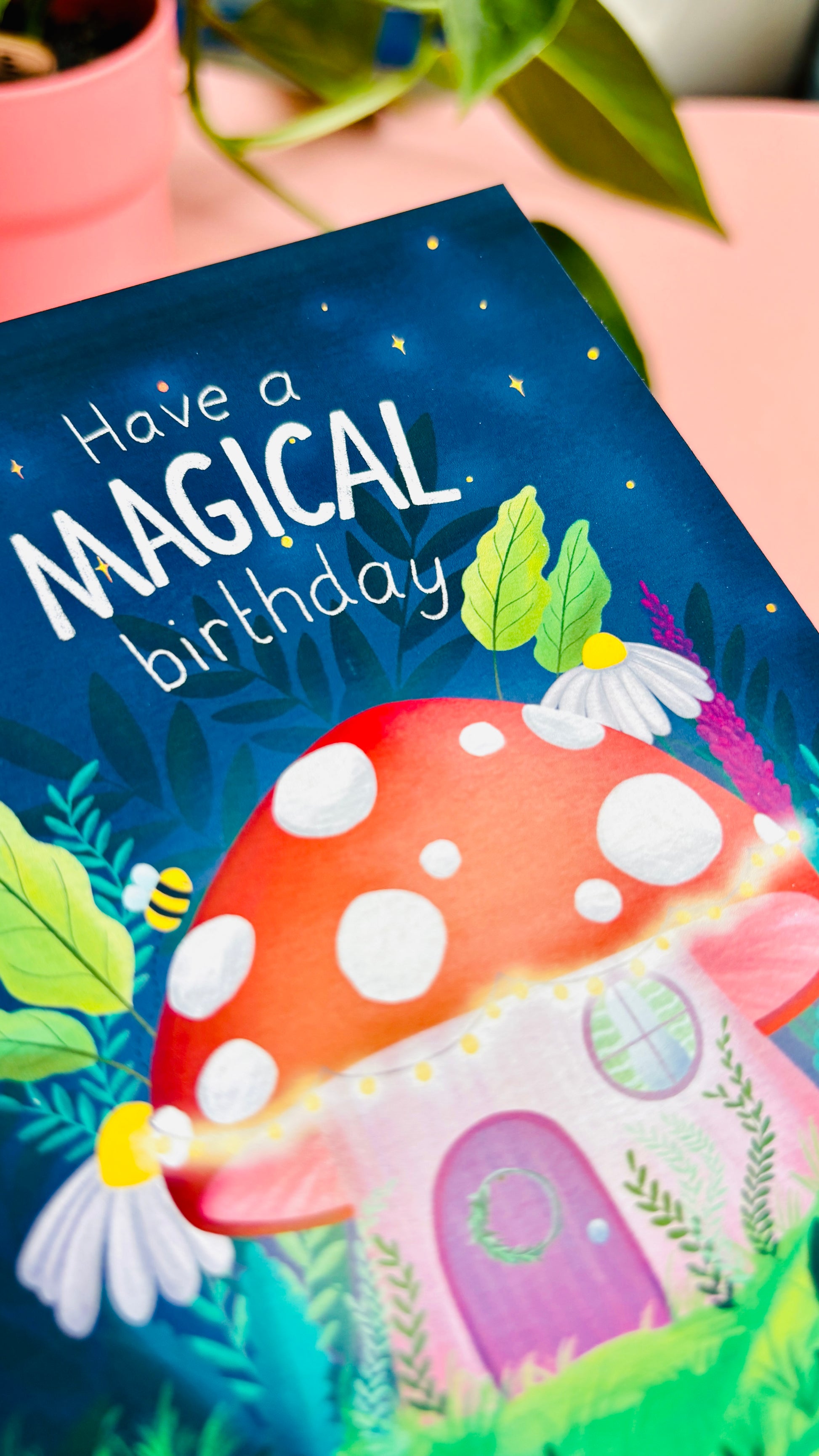 Magical handmade birthday card of a cute mushroom fairy cottage surrounded by botanical plants and flowers with a fantasy vibe reads “have a magical birthday”