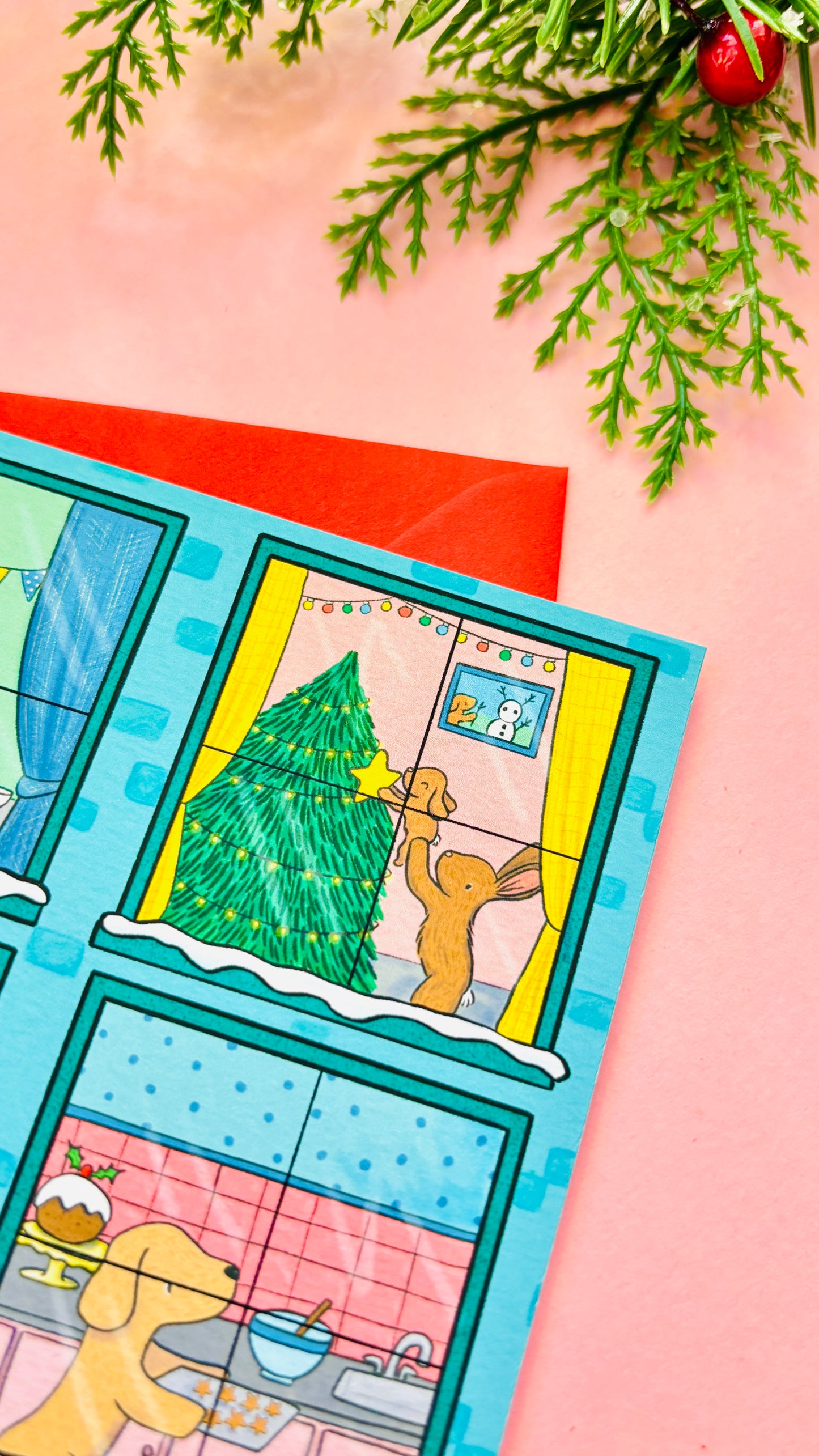 Illustrated Christmas card designed like a festive building with animals in each window, including bunnies, penguins, a cat, a dog, robins, and ducks.