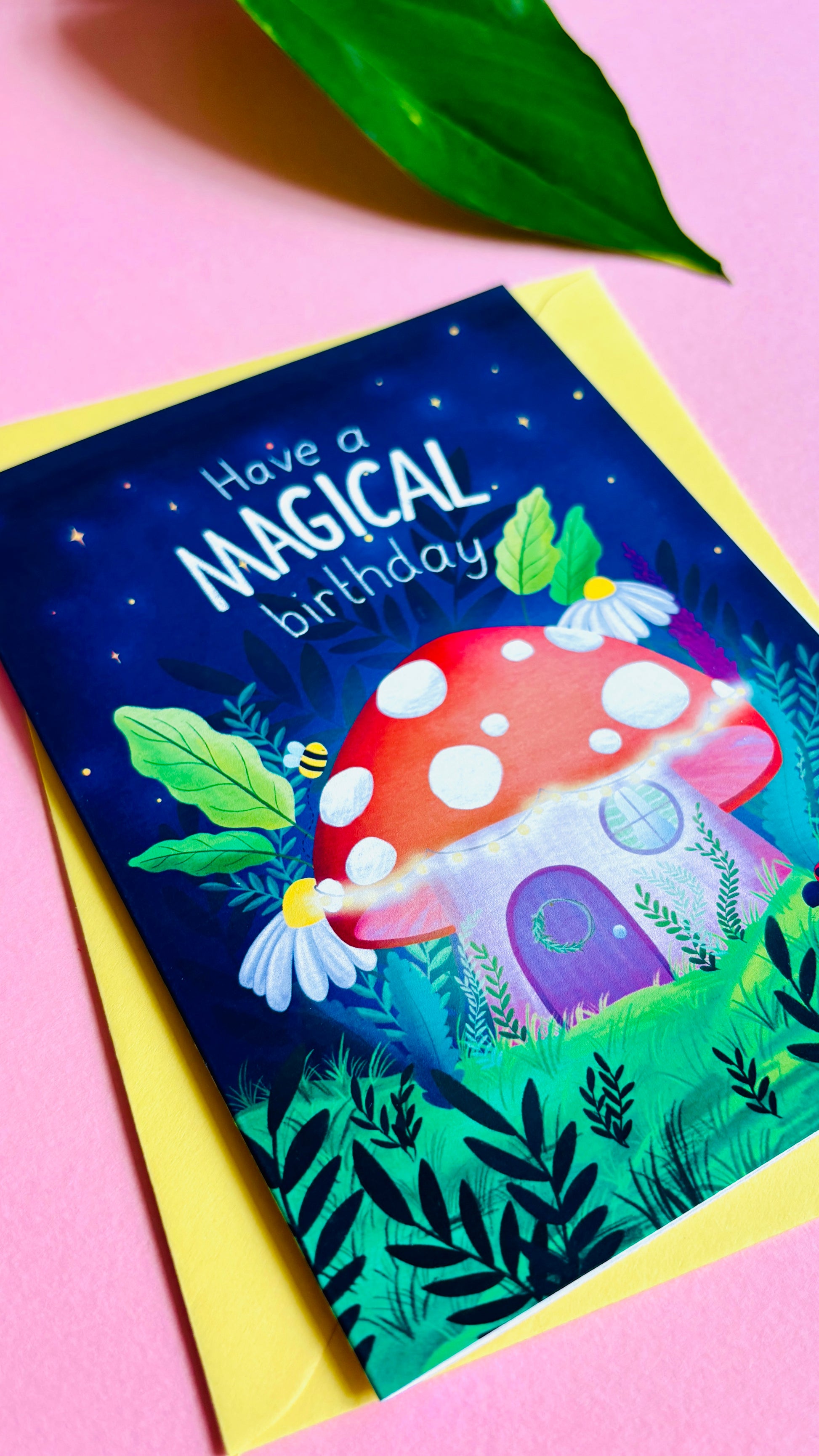 Magical handmade birthday card of a cute mushroom fairy cottage surrounded by botanical plants and flowers with a fantasy vibe reads “have a magical birthday”