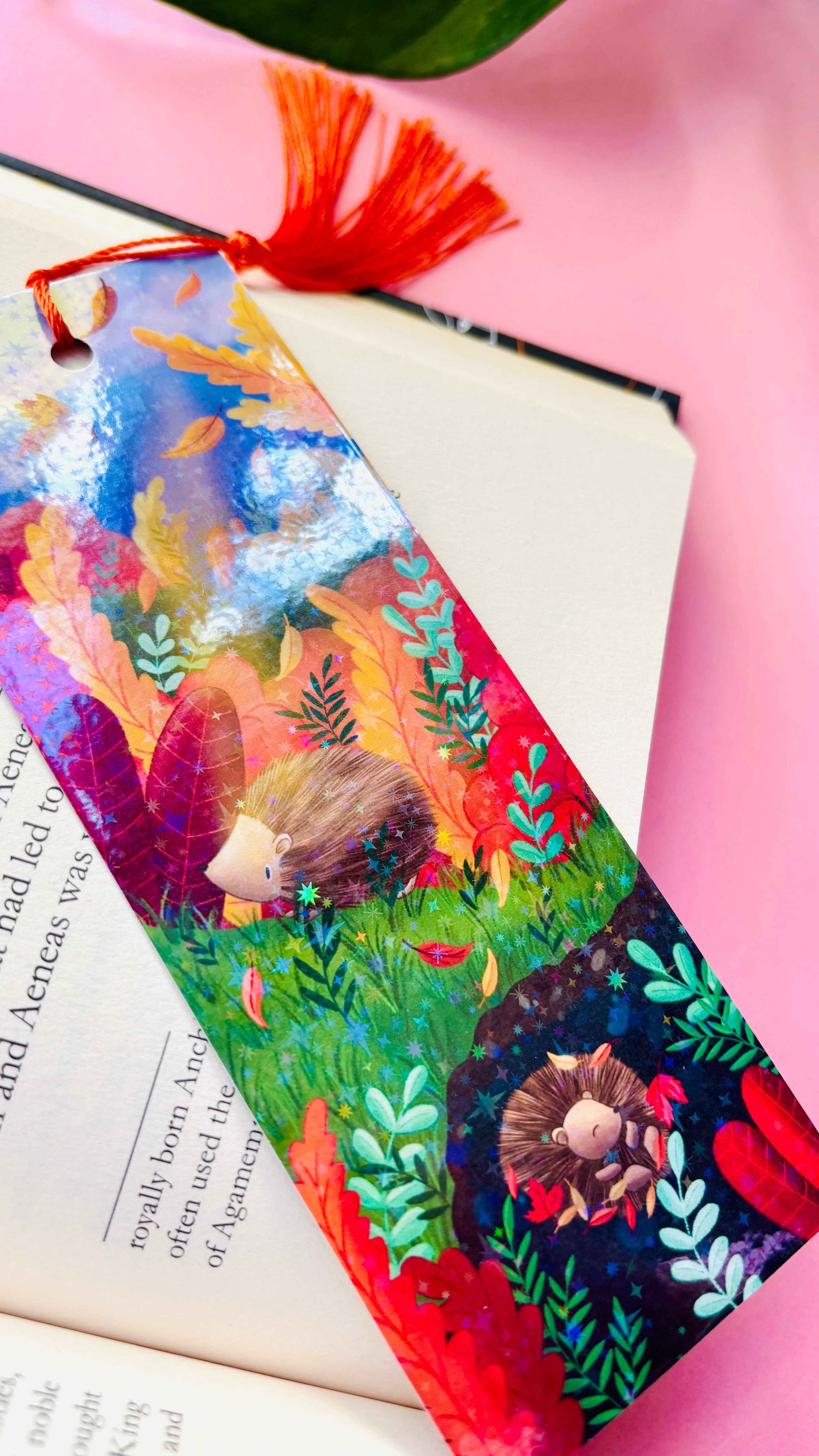 Hand-illustrated Autumn Hedgehog holographic bookmark, handmade in the UK. Rainbow shimmer finish with a tassel, perfect for marking pages in books, journals, or planners.
