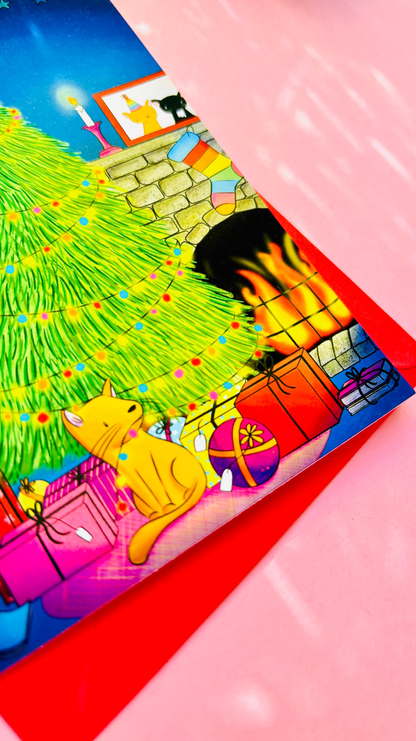 Handmade Christmas card with two playful cats by a decorated tree and fireplace, perfect festive greeting for cat lovers.