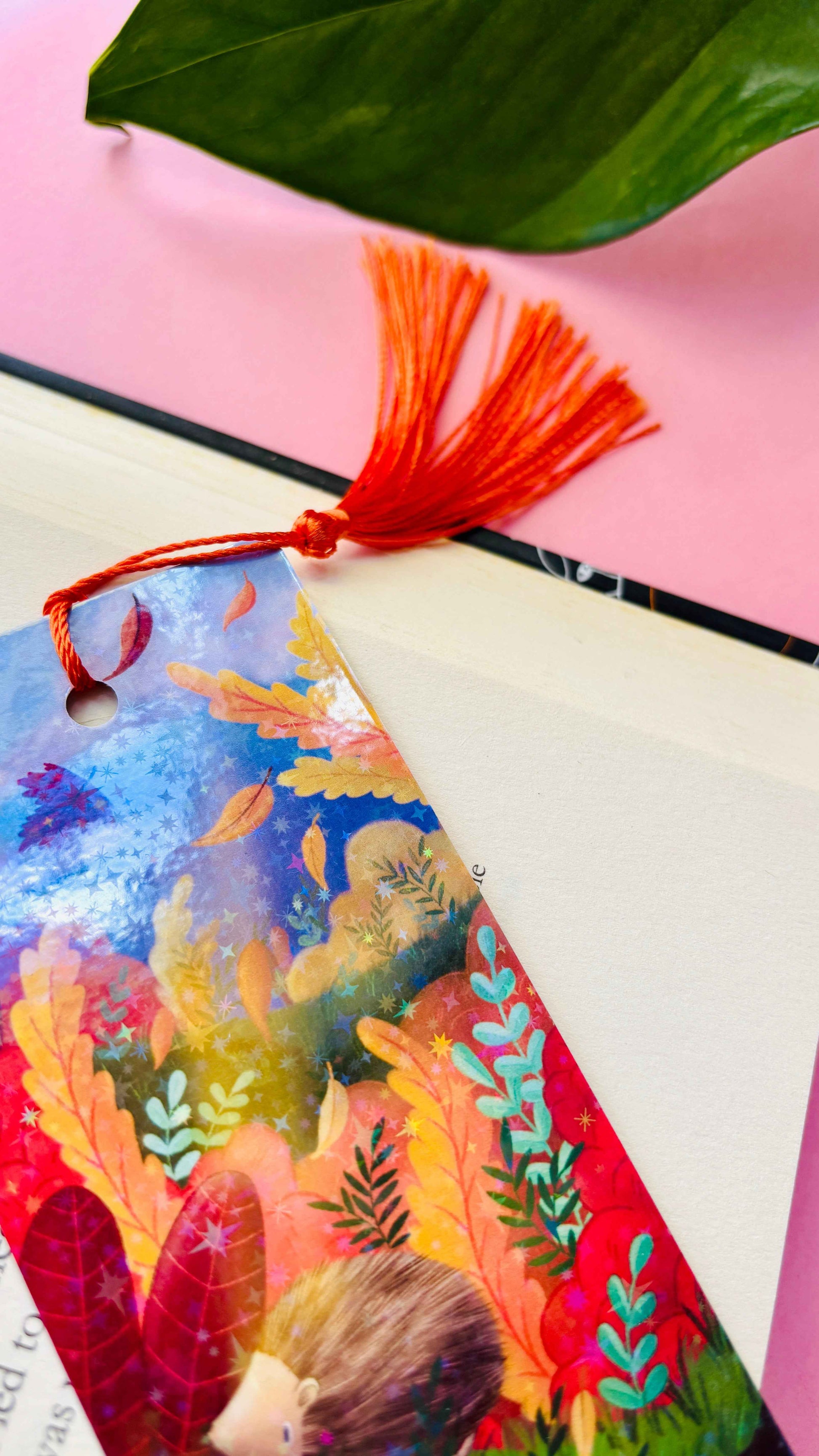 Hand-illustrated Autumn Hedgehog bookmark with holographic finish and tassel – sustainable and handmade in the UK.