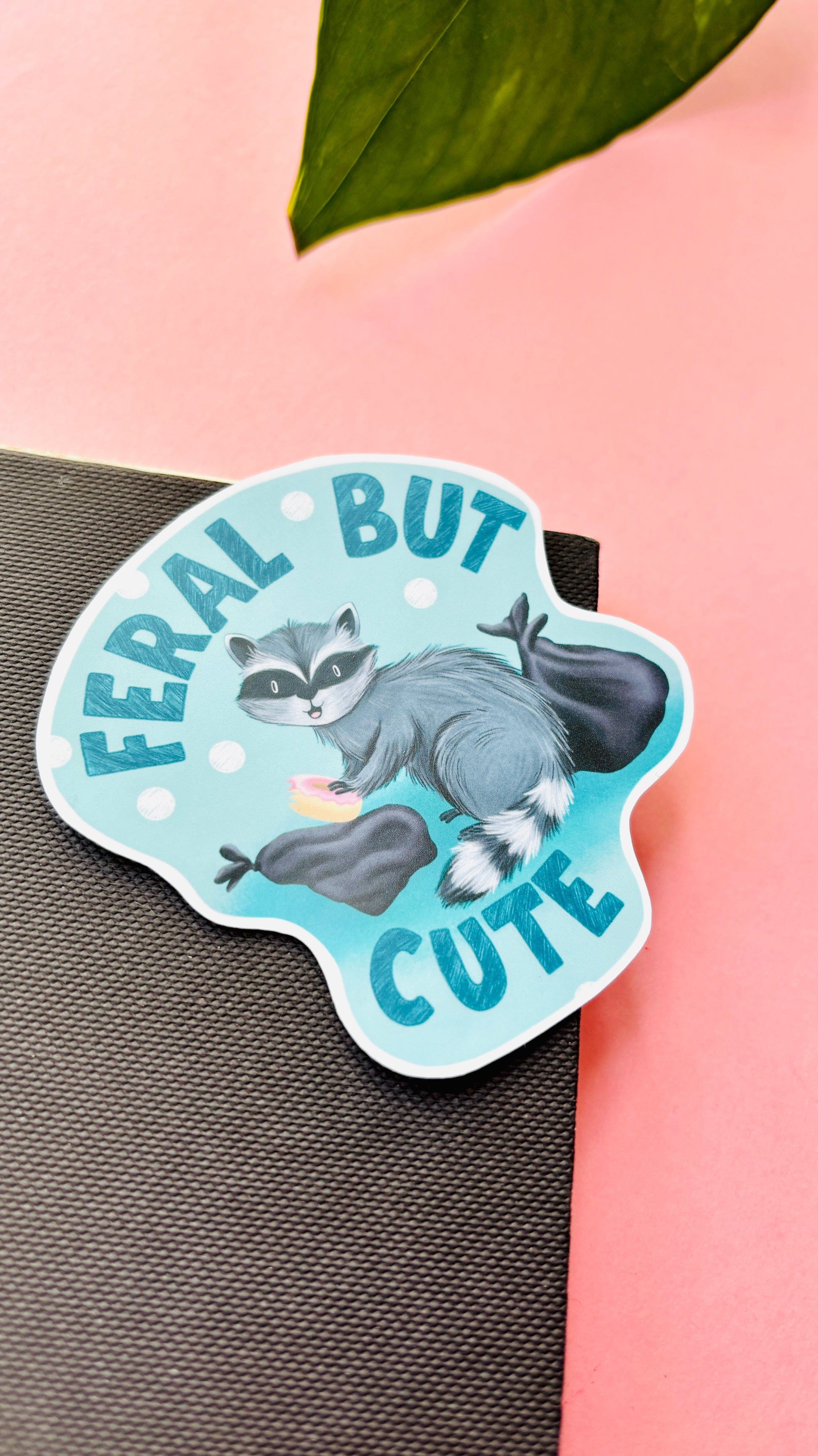 Cute raccoon sticker with “Feral but Cute” text – perfect for laptops, water bottles, and notebooks.