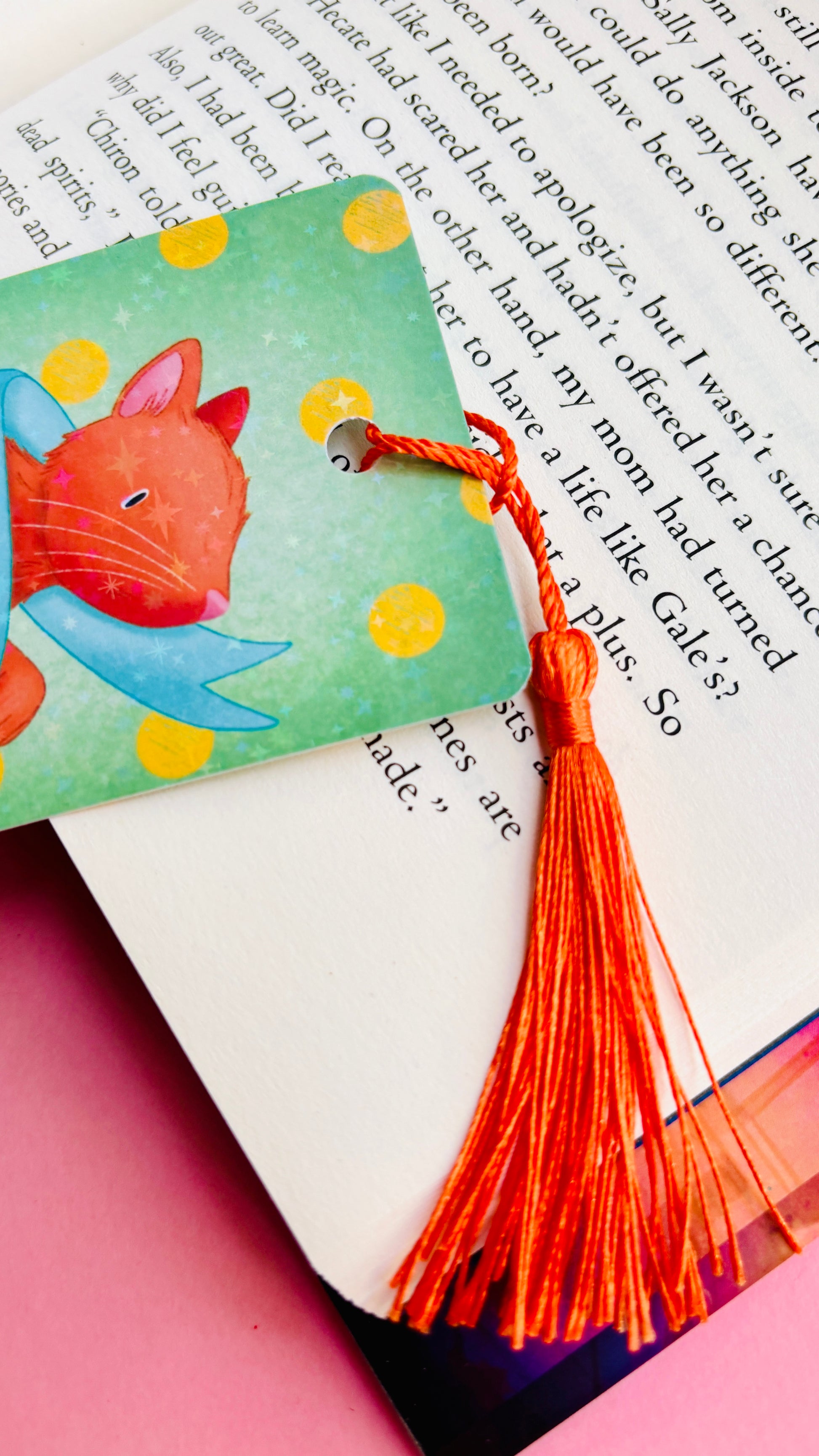 Hand-illustrated ginger cat holographic bookmark featuring “You are here” banner, double-sided design, and rainbow holographic finish, ideal gift for cat lovers and readers.