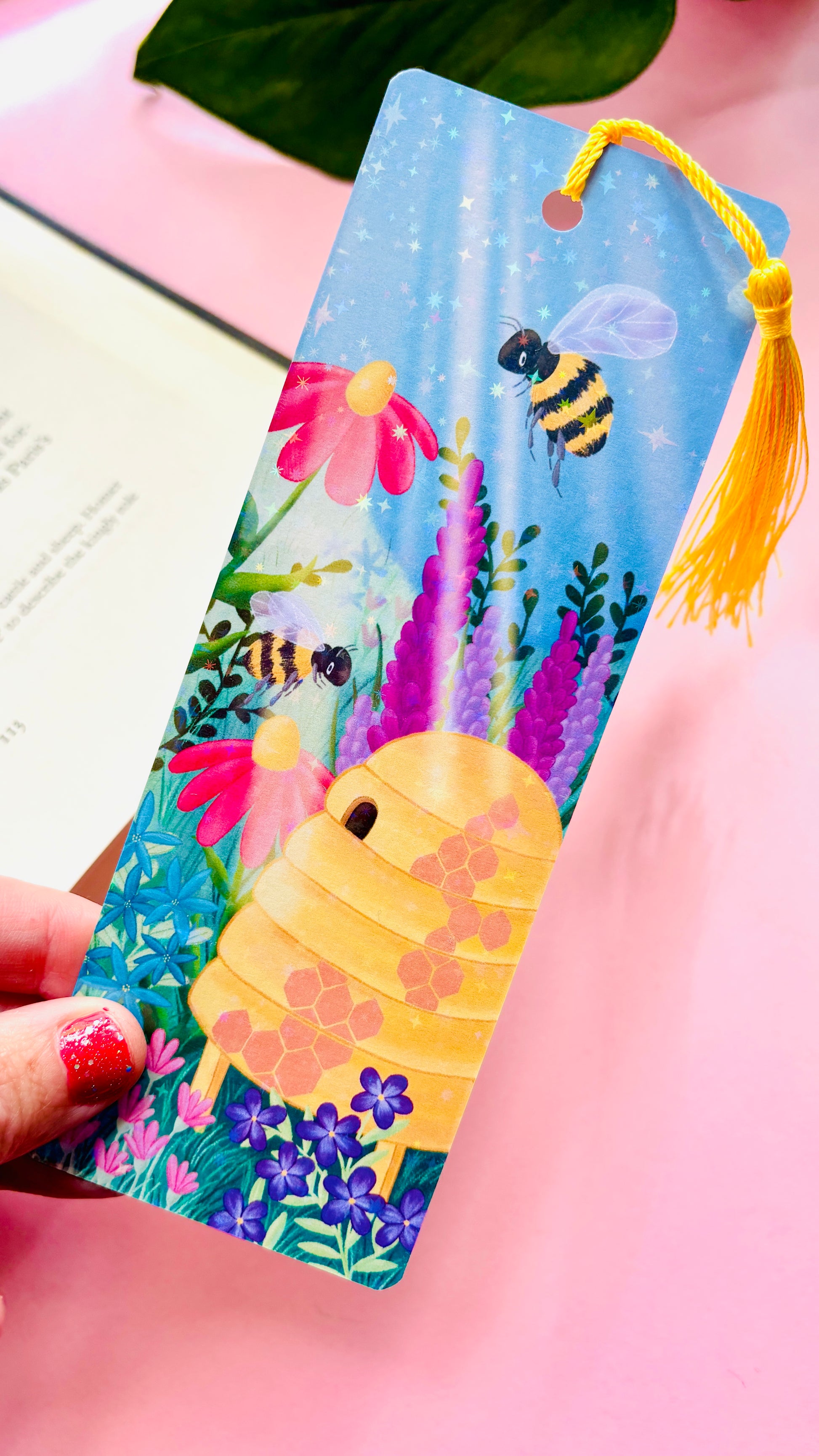 Handmade bee and wildflower bookmark with rainbow holographic finish, featuring playful bees and a colorful meadow, perfect for book lovers and nature enthusiasts