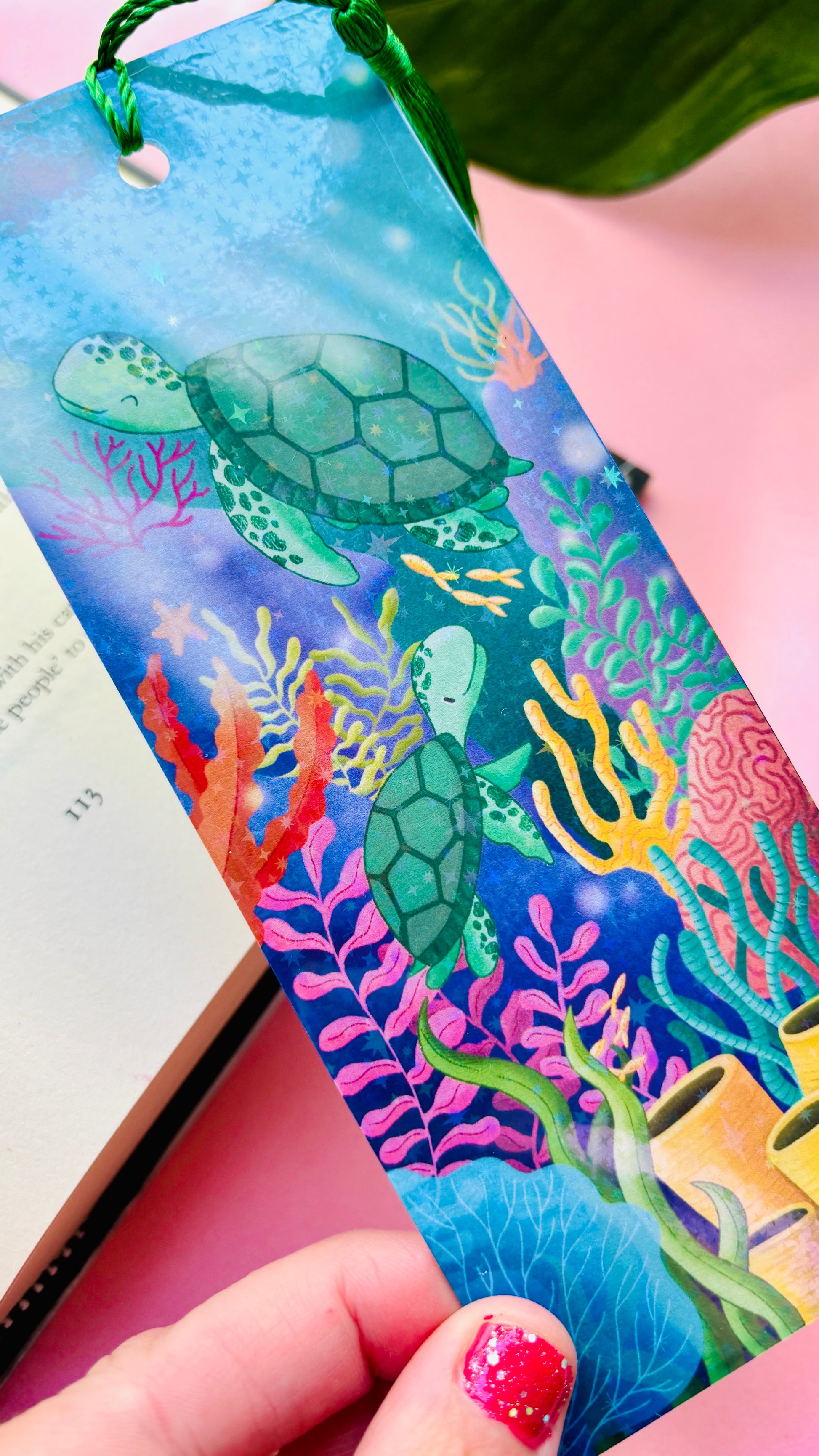 Hand-illustrated sea turtle bookmark with two turtles swimming in a vibrant coral reef – double-sided, rainbow holographic finish with green tassel, handmade UK gift for book lovers and ocean enthusiasts