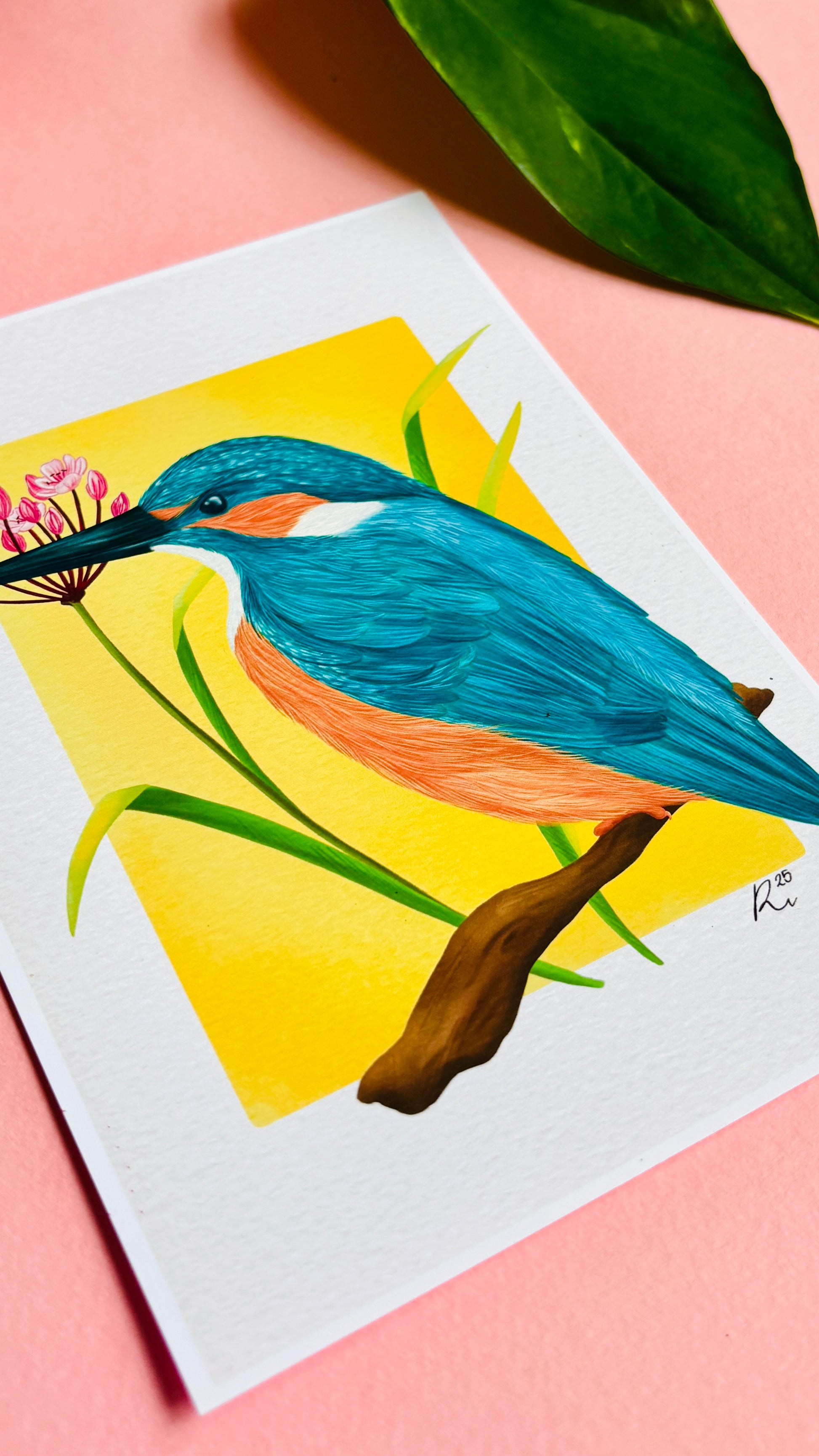 Kingfisher nature art print of a vibrant kingfisher bird and pink flowering rush plant inspired by British wildlife. Setting against a yellow backdrop this bold print is perfect for nature lovers and fans of maximalist decor.