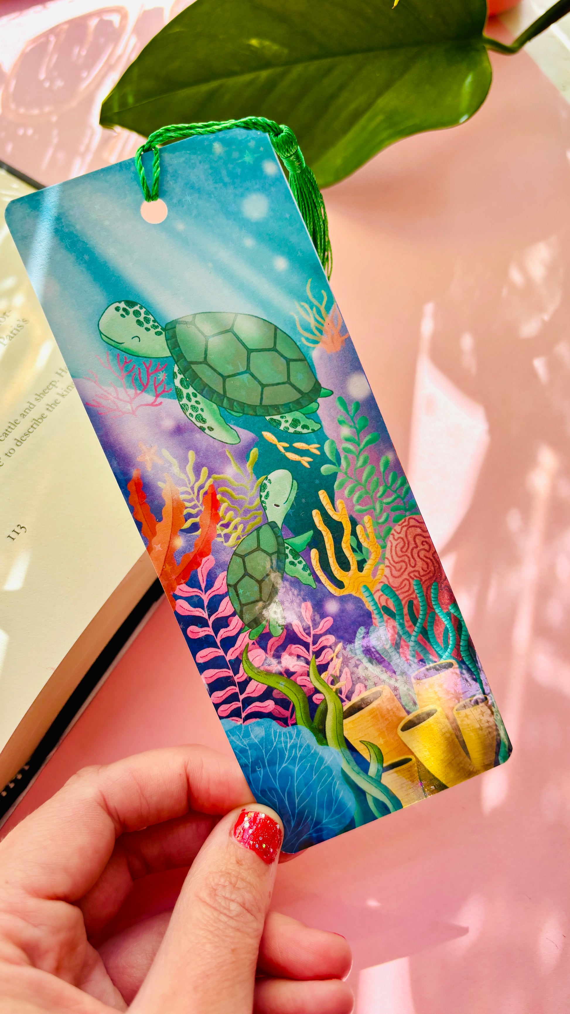 Hand-illustrated sea turtle bookmark with two turtles swimming in a vibrant coral reef – double-sided, rainbow holographic finish with green tassel, handmade UK gift for book lovers and ocean enthusiasts