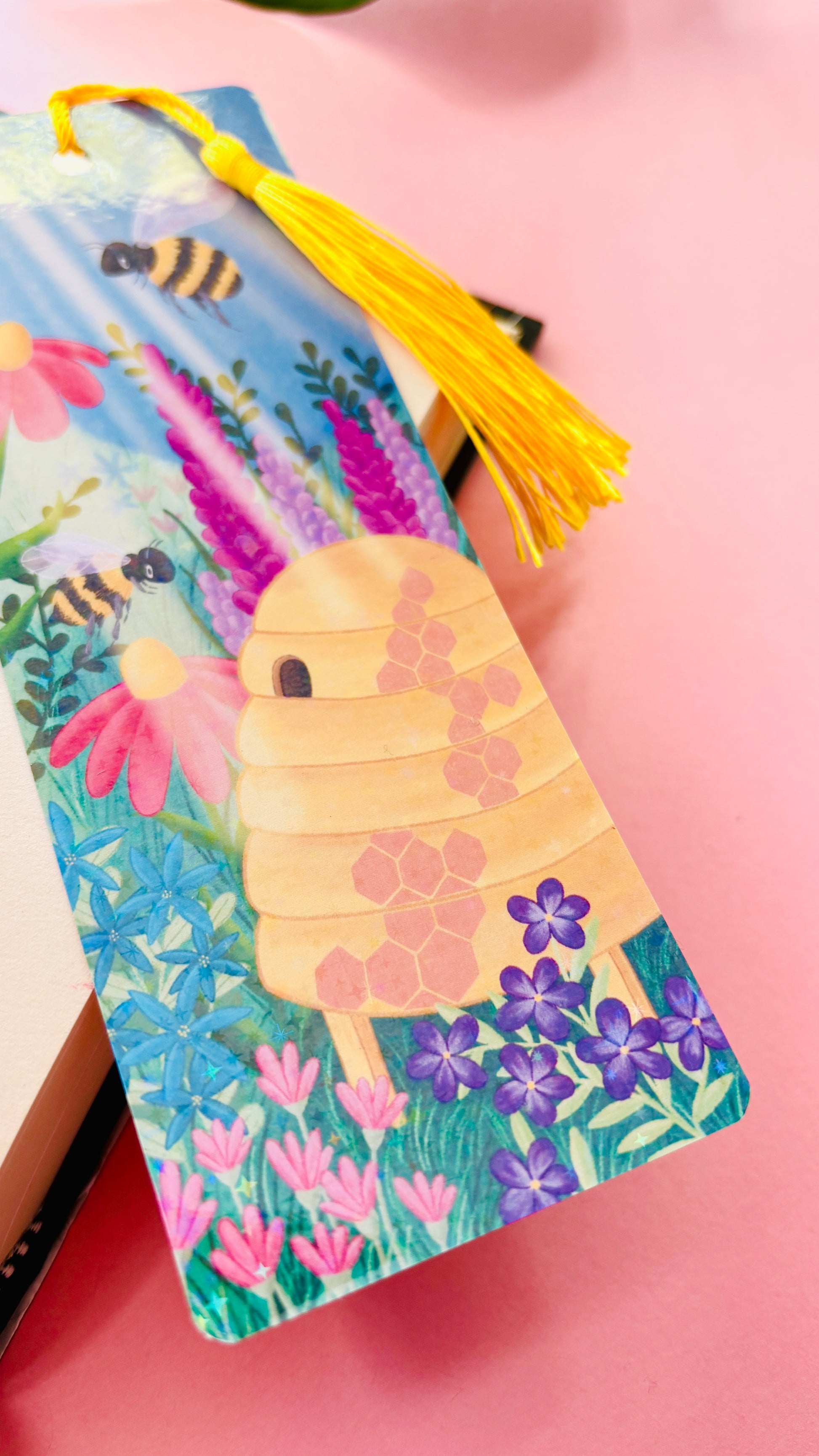 Hand-illustrated wildflower and bee bookmark, eco-friendly FSC-certified cardstock, double-sided design with holographic laminate for durability.