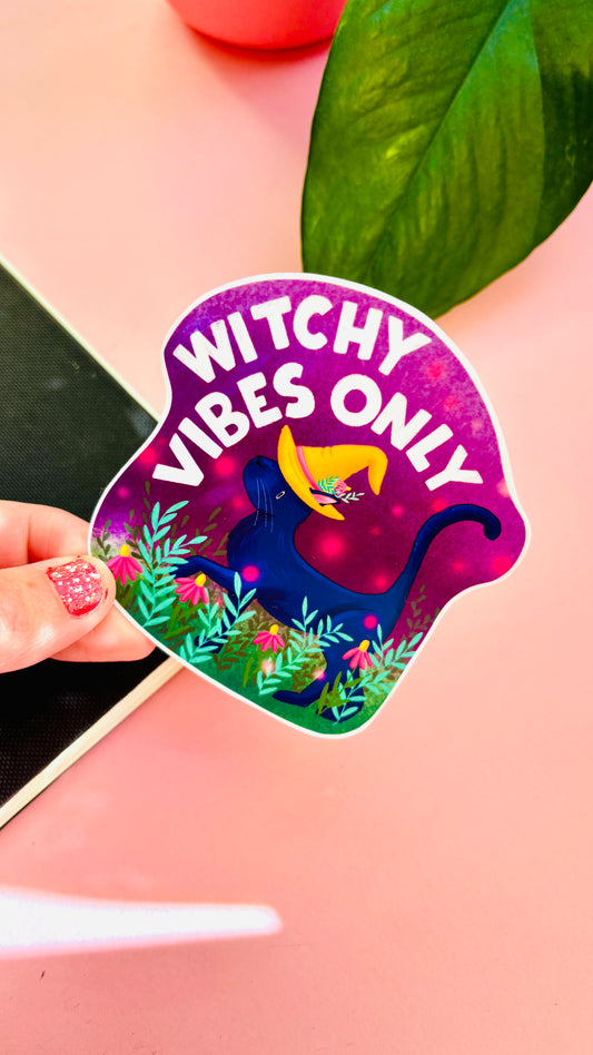 Hand-illustrated “Witchy Vibes Only” Halloween vinyl sticker featuring a cute black cat in a witch’s hat surrounded by flowers – perfect for laptops, journals, and water bottles.