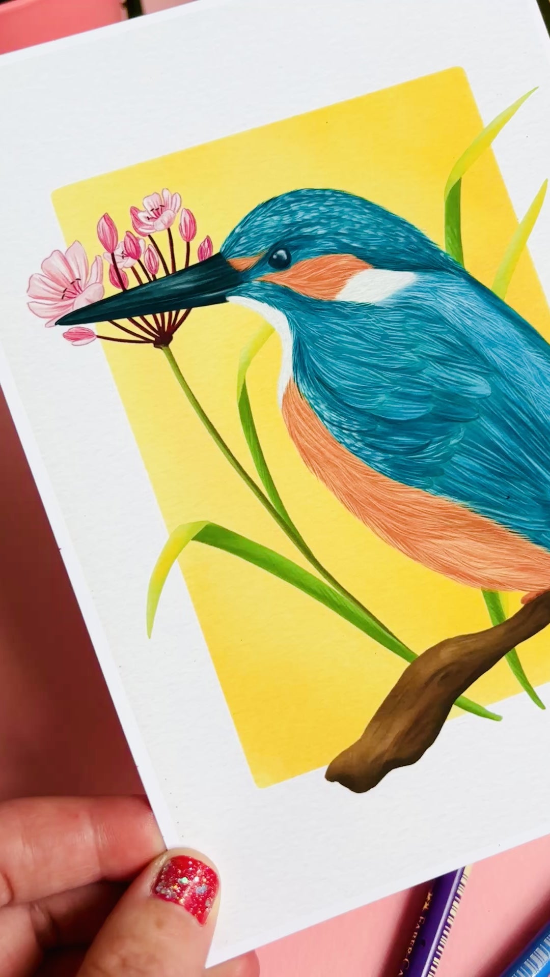 Kingfisher nature art print of a vibrant kingfisher bird and pink flowering rush plant inspired by British wildlife. Setting against a yellow backdrop this bold print is perfect for nature lovers and fans of maximalist decor.