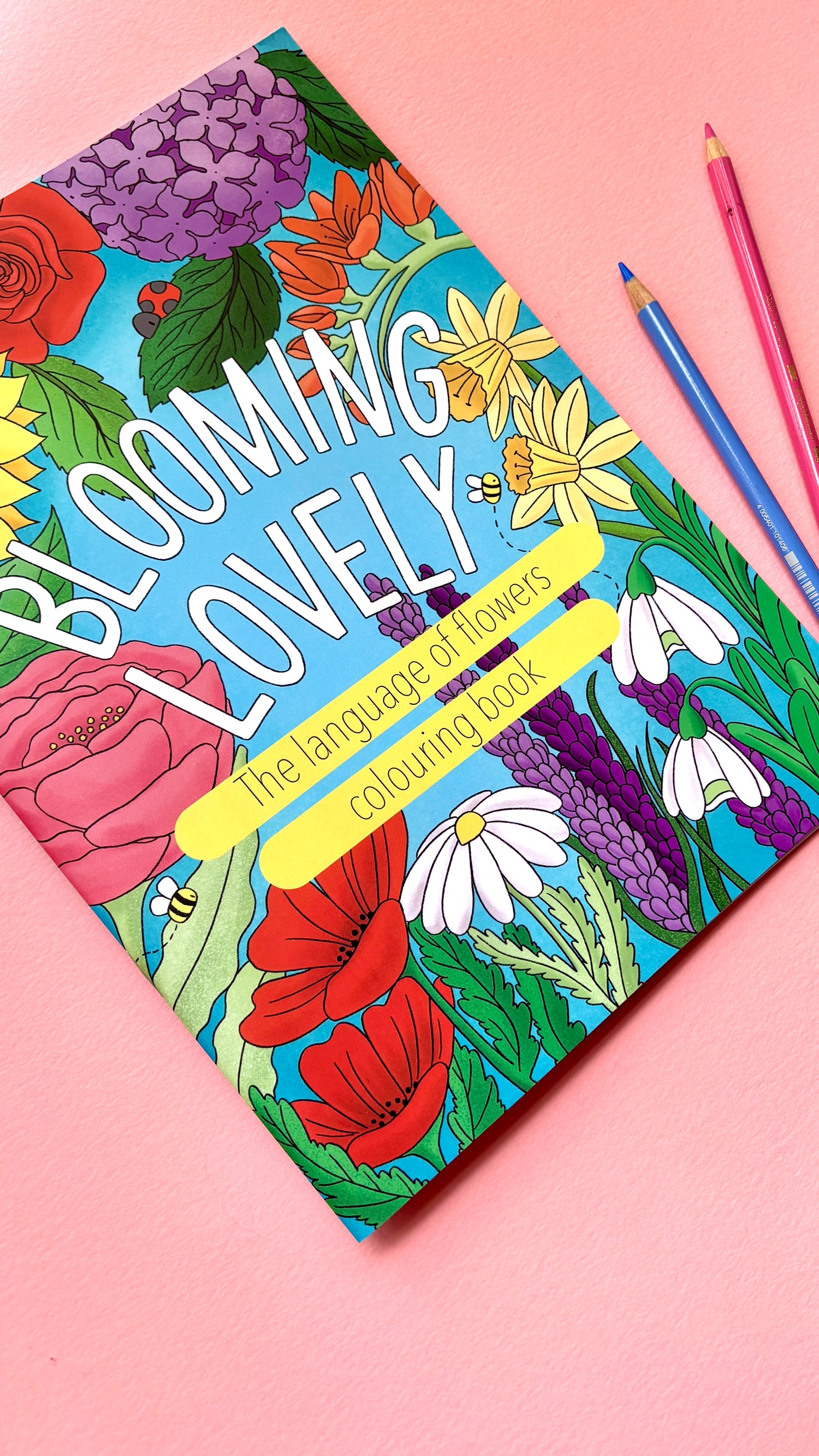Adult colouring book with floral, bold easy to colour design. Reads ‘blooming lovely: the language of flowers colouring book’ surrounded by colourful flowers and botanicals.