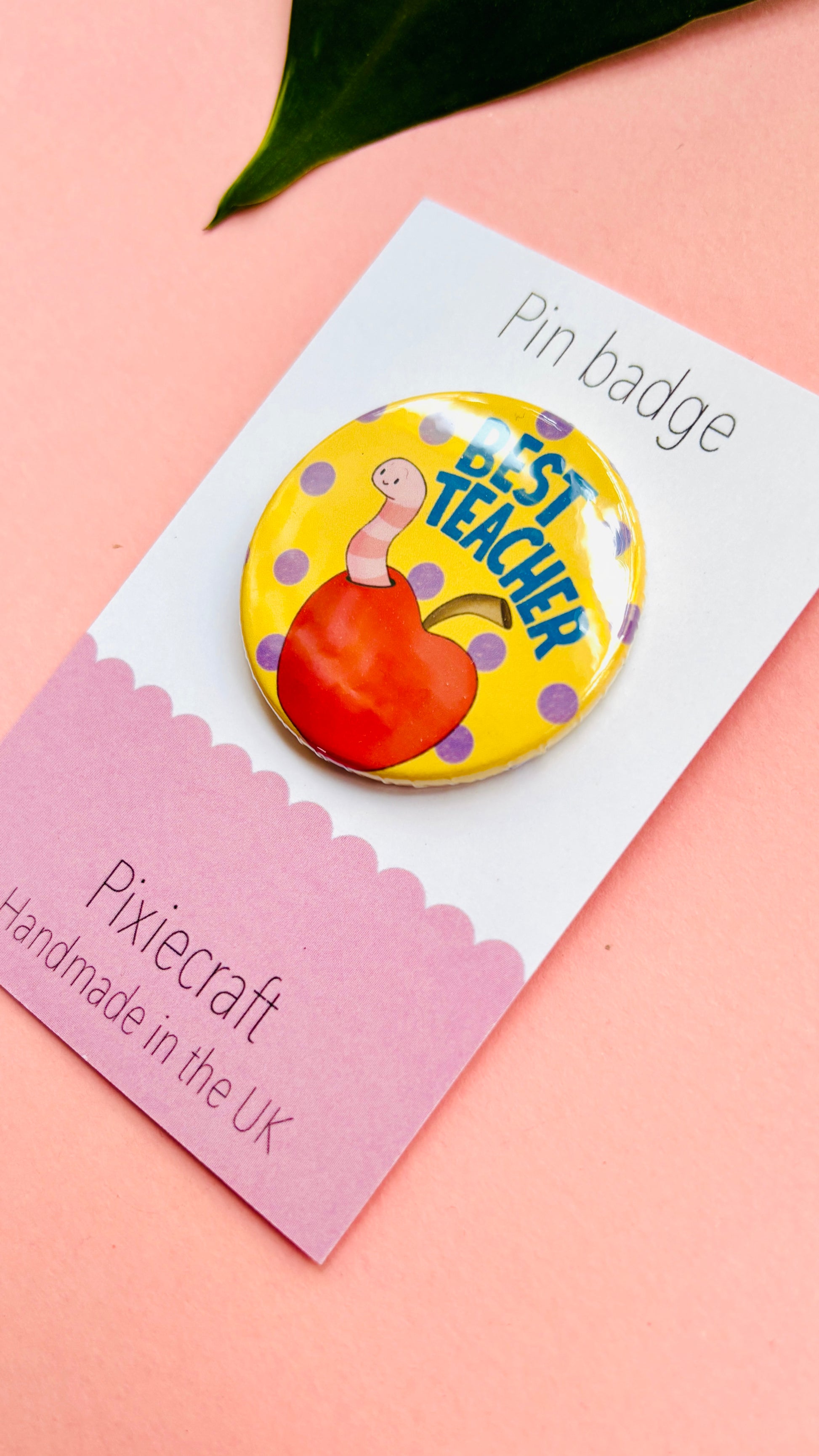 Teacher gift pin badge or magnet that reads ‘best teacher’ above a cute worm in a bright red apple. Presented on a colourful backing card ready to gift to your favourite teacher and say thank you.