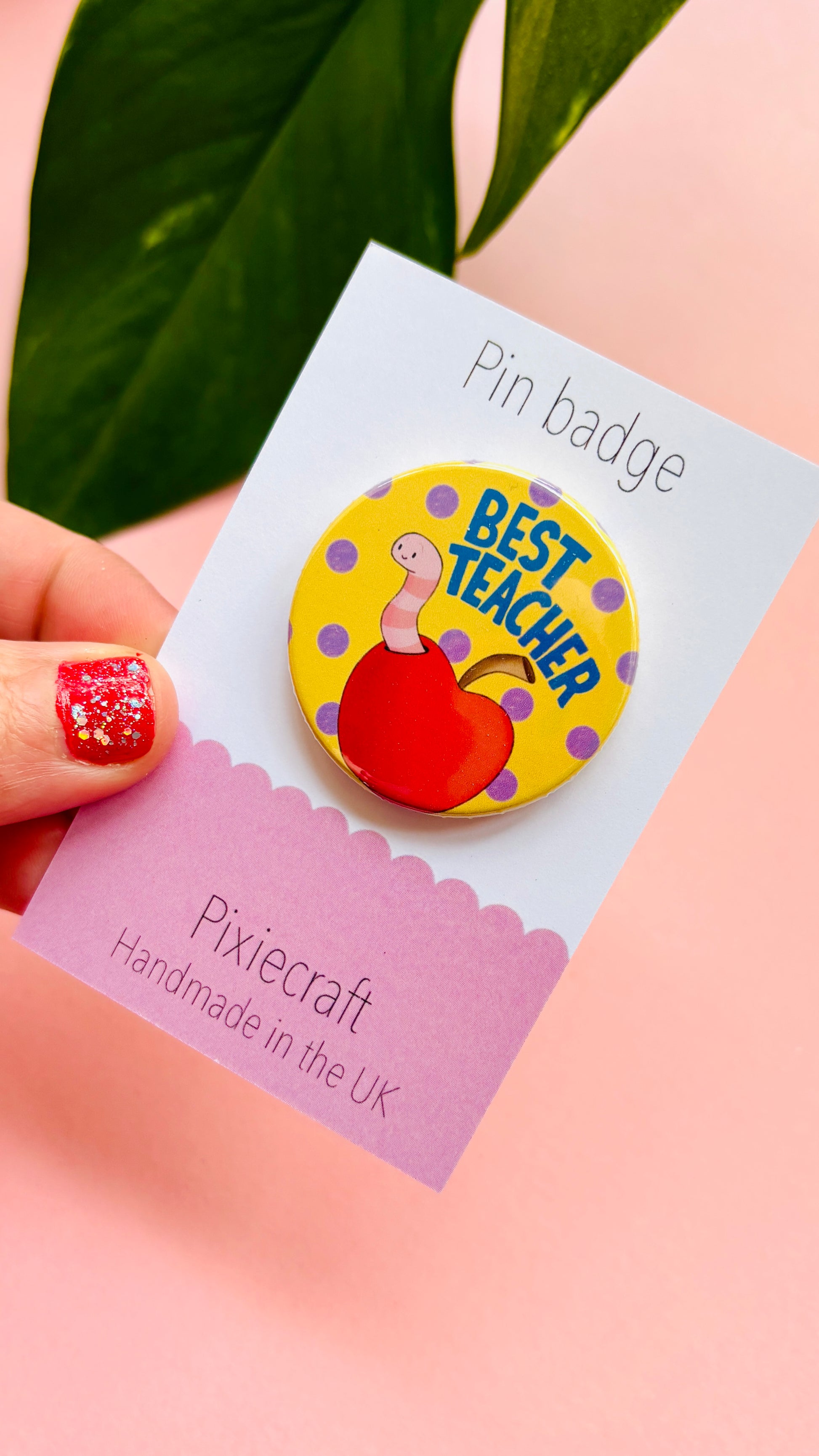 Teacher gift pin badge or magnet that reads ‘best teacher’ above a cute worm in a bright red apple. Presented on a colourful backing card ready to gift to your favourite teacher and say thank you.