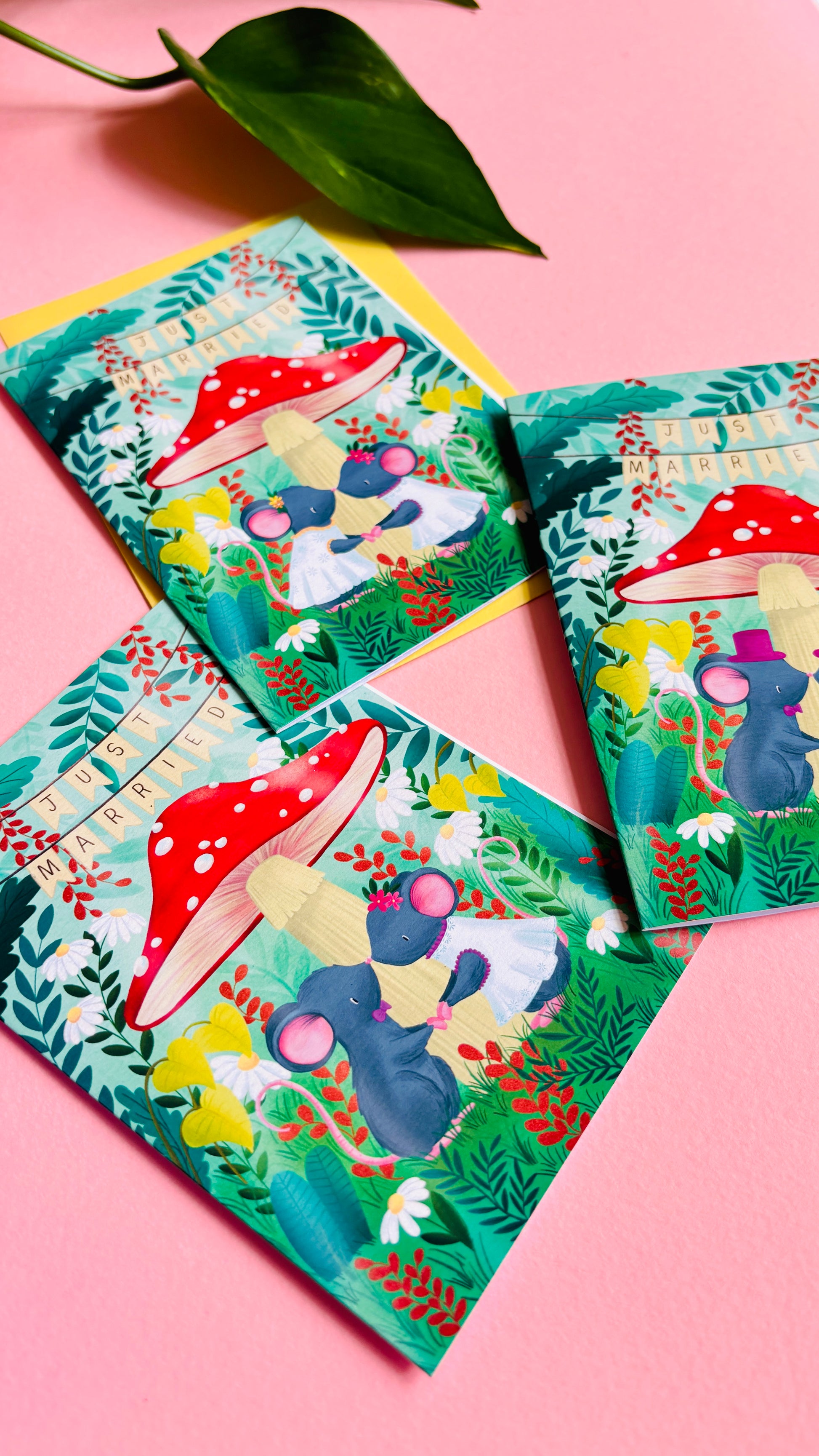 Handmade wedding card with a fantasy forest theme of two mice under a whimsical toadstool in a vibrant woodland setting full of flowers and plants. This handmade card is blank on the inside for your message a d supplied with a yellow envelope 
