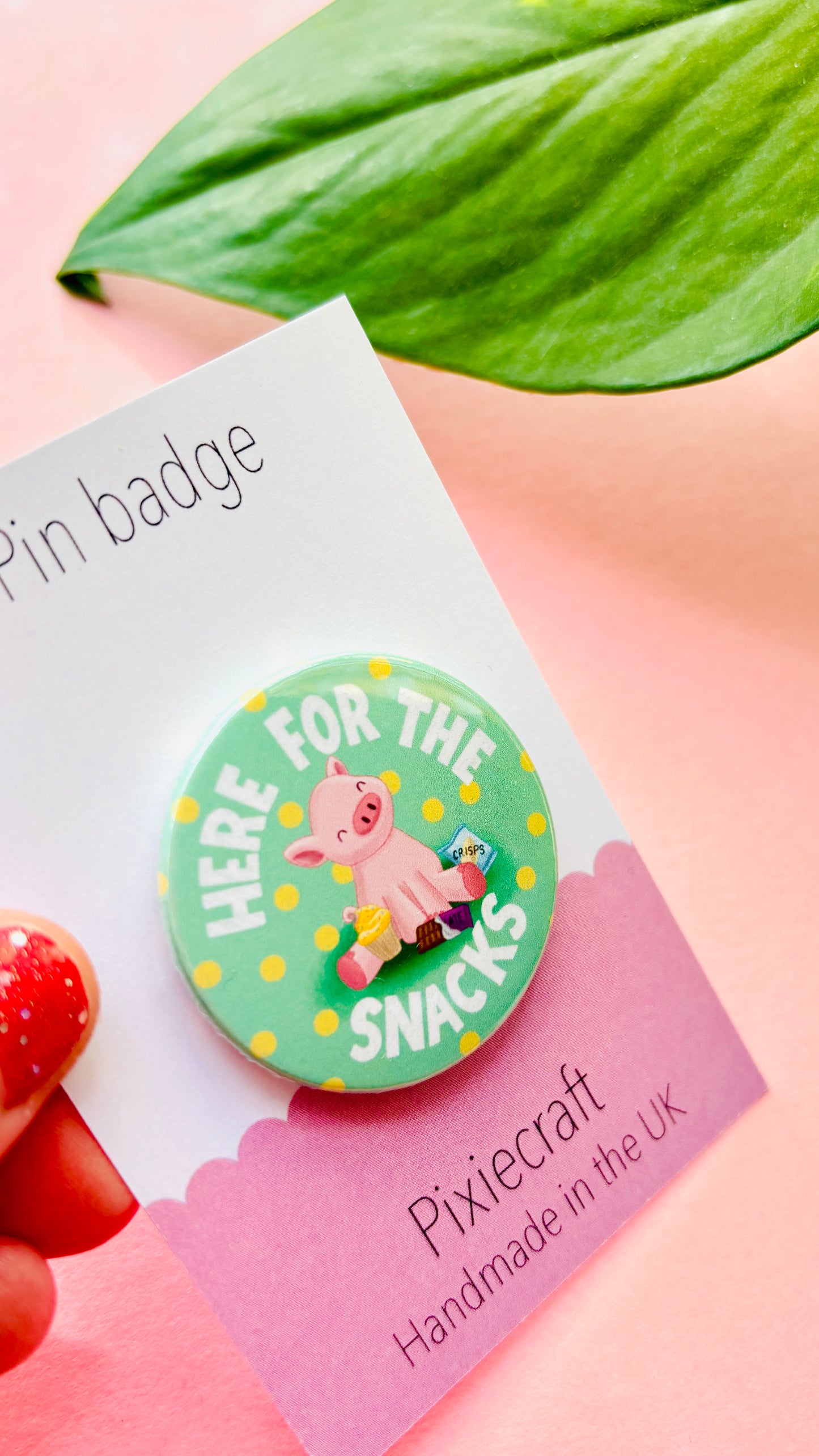 Hand-illustrated ‘Here for the Snacks’ pig badge with snacks, available as a pin or fridge magnet, handmade in the UK.”