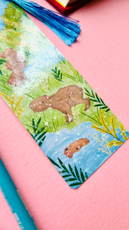 Bookmark with capybara illustration on a pink surface