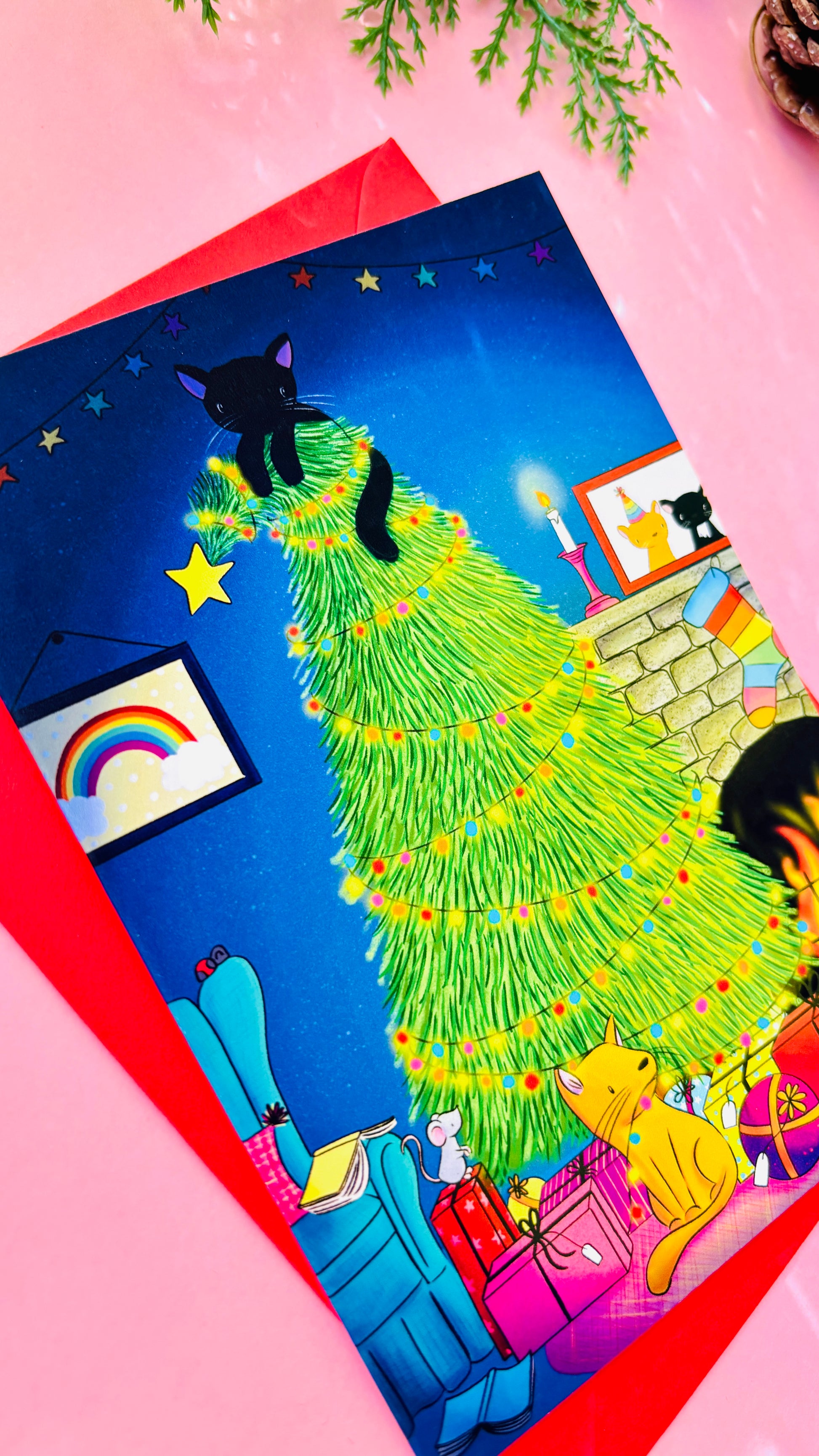 Handmade Christmas card with two playful cats by a decorated tree and fireplace, perfect festive greeting for cat lovers.