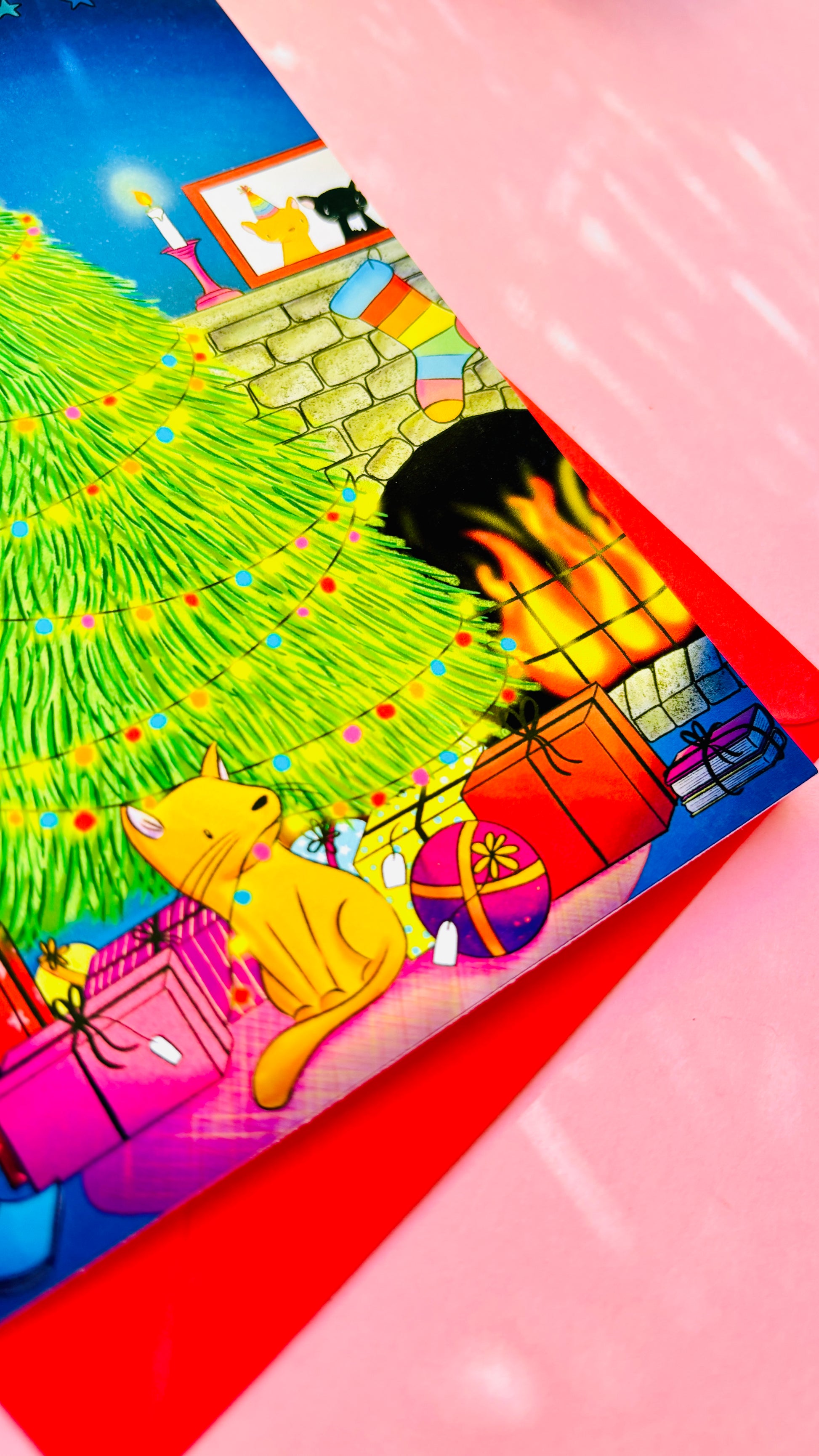 Handmade Christmas card with two playful cats by a decorated tree and fireplace, perfect festive greeting for cat lovers.