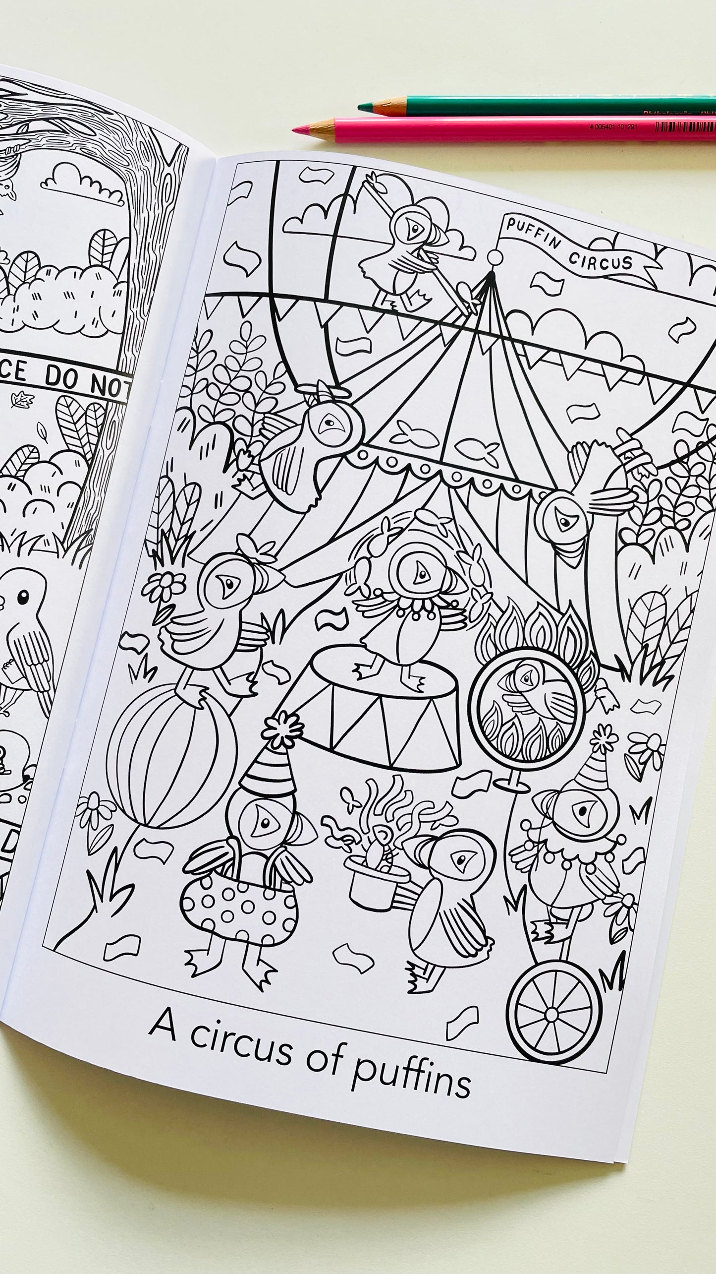 A colouring page featuring a circus made up of puffins 