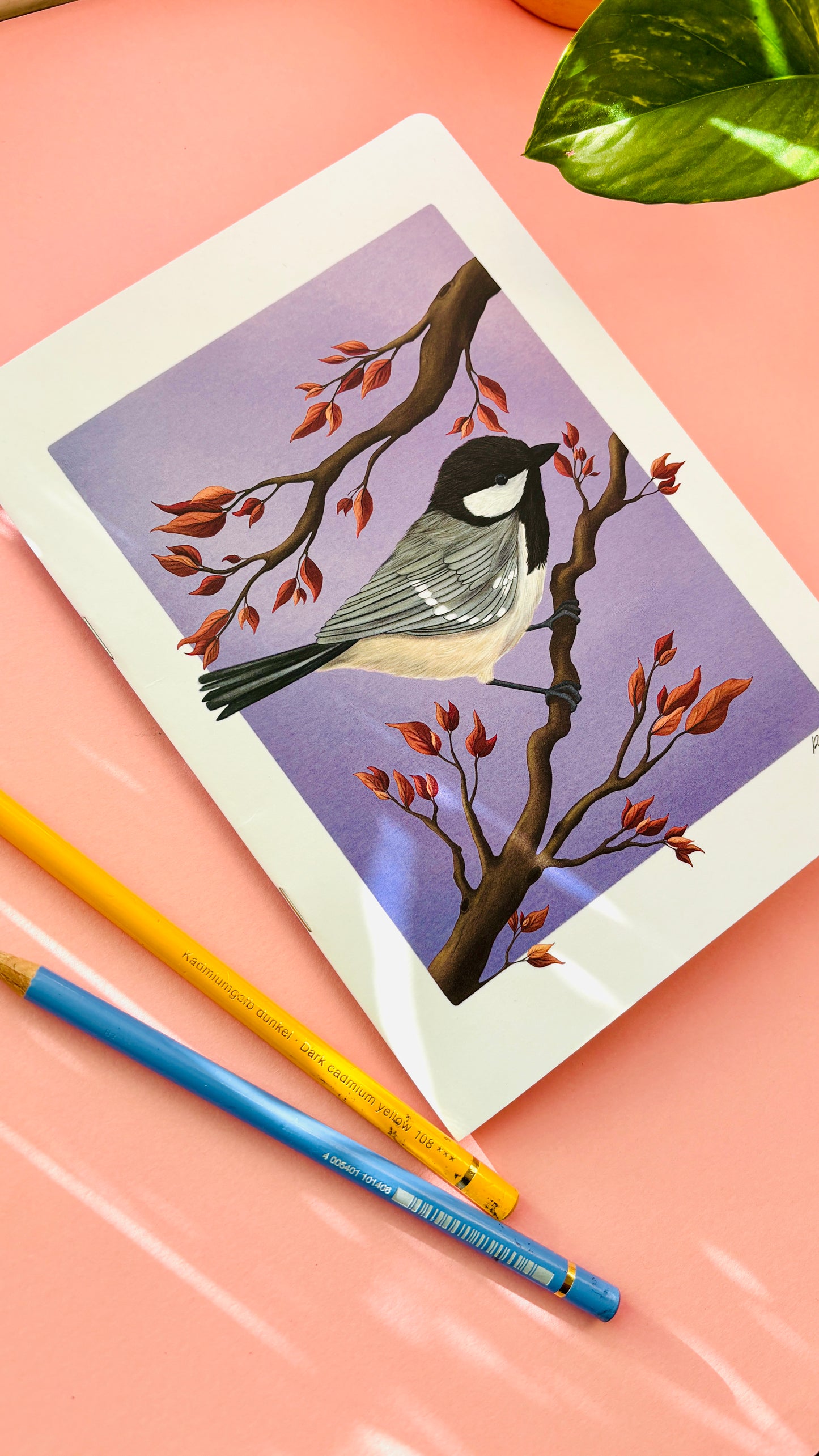 Full-colour illustrated cover of an A5 notebook featuring a coal tit bird on a purple background, printed in the UK