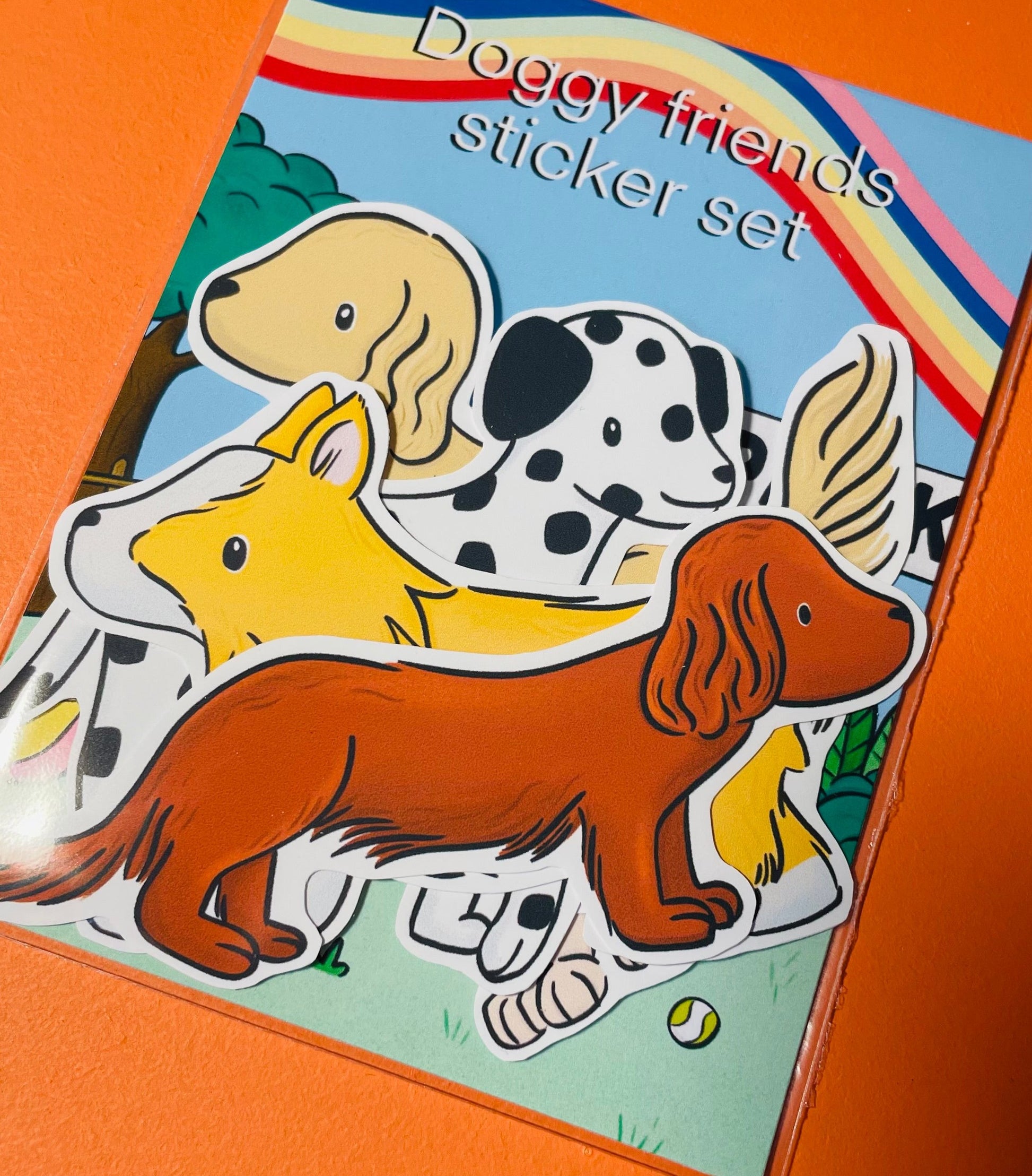 A cute sticker page of five illustrated dog stickers including a sausage dog, Dalmatian, pug, corgi and cocker spaniel