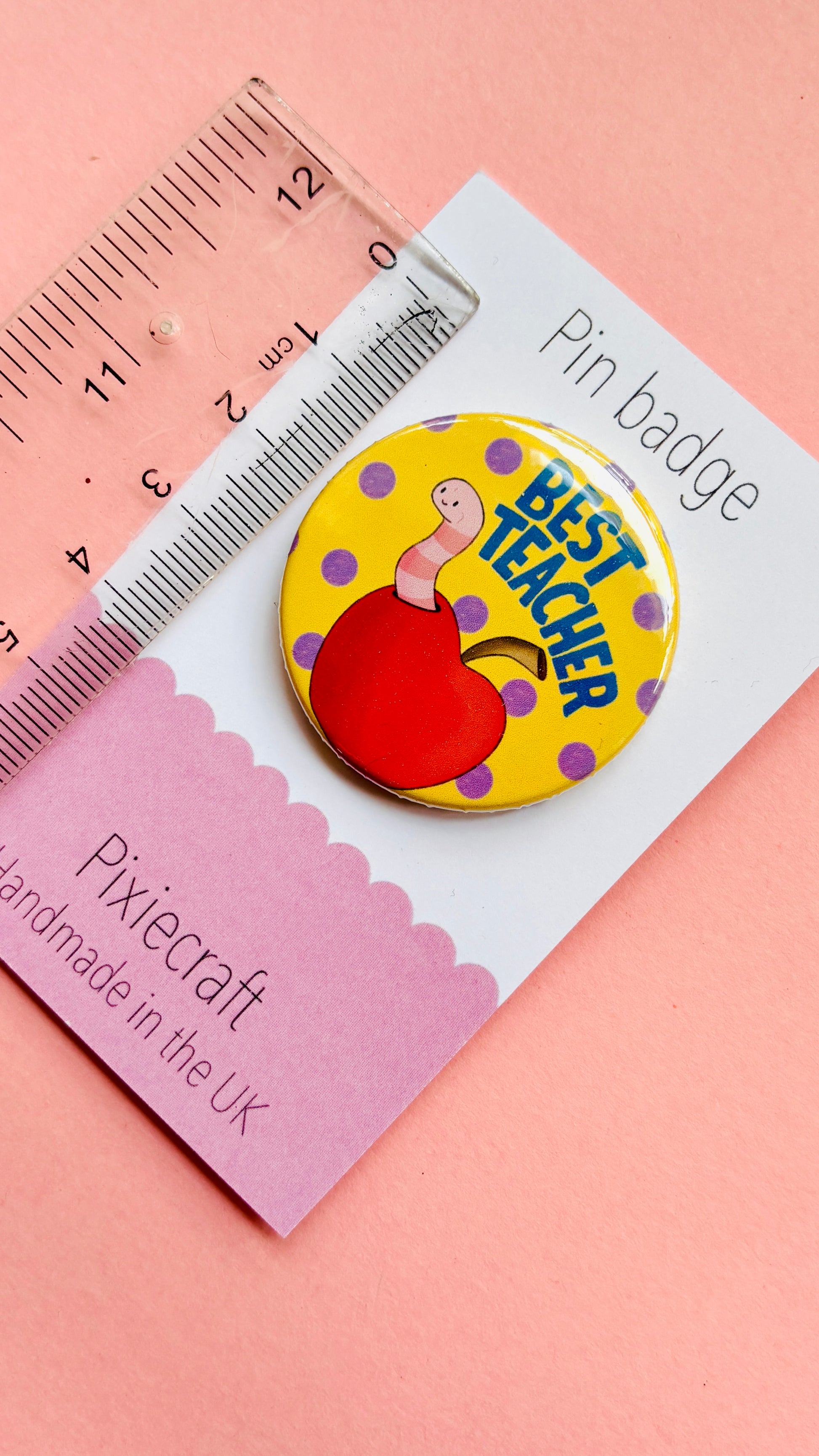 Teacher gift pin badge or magnet that reads ‘best teacher’ above a cute worm in a bright red apple. Presented on a colourful backing card ready to gift to your favourite teacher and say thank you.