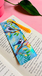 Handmade bookmark with illustration of two cute long tailed tits sitting on delicate branches surrounded by yellow flowers. Finished with rainbow holographic laminate, rounded corners and a tassel. Ideal gift for bookish gifts lovers. 