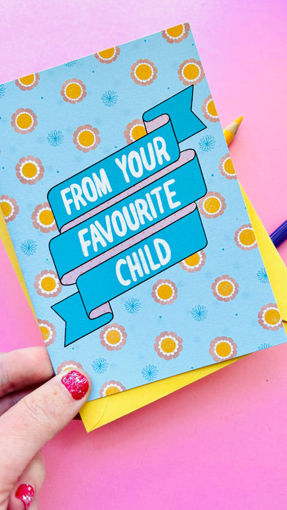 A funny handmade greetings card for mum or dad and reads “from your favourite child” on a blue and pink banner against a colourful retro feel floral background. Supplied with a yellow envelope.