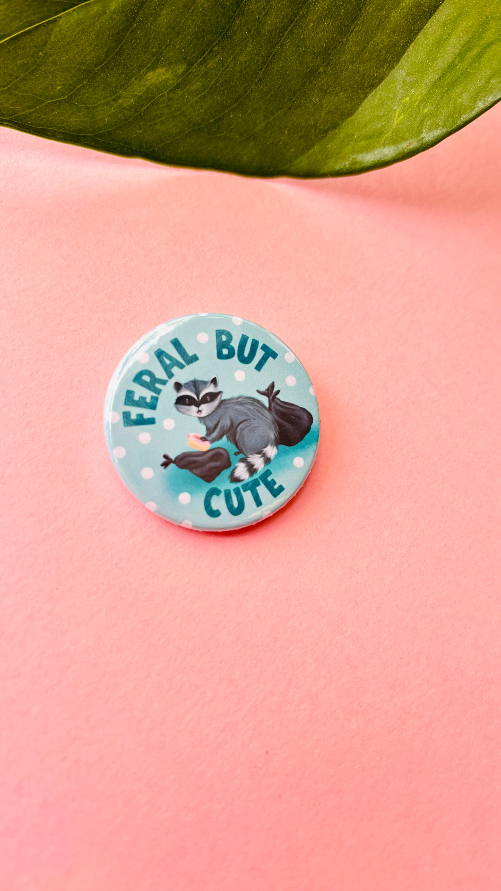 Handmade “Feral but Cute” raccoon badge or magnet – cute illustrated wildlife gift for animal lovers and nature fans.