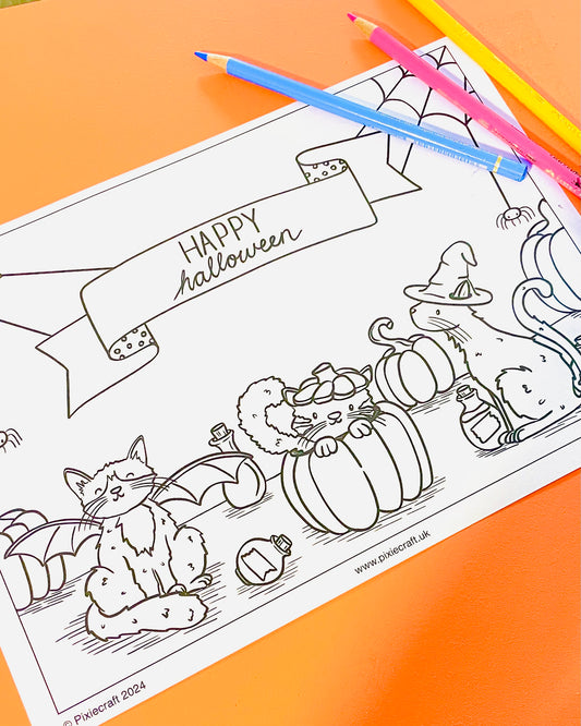 A free illustrated colouring page of three Halloween cats with pumpkins and spider webs.