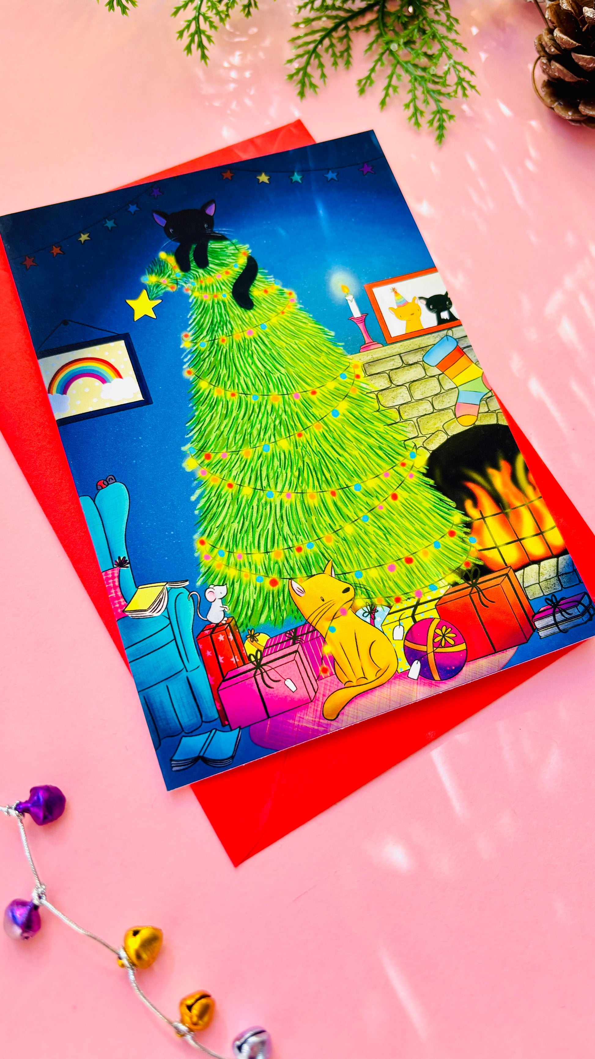 Handmade Christmas card with two playful cats by a decorated tree and fireplace, perfect festive greeting for cat lovers.