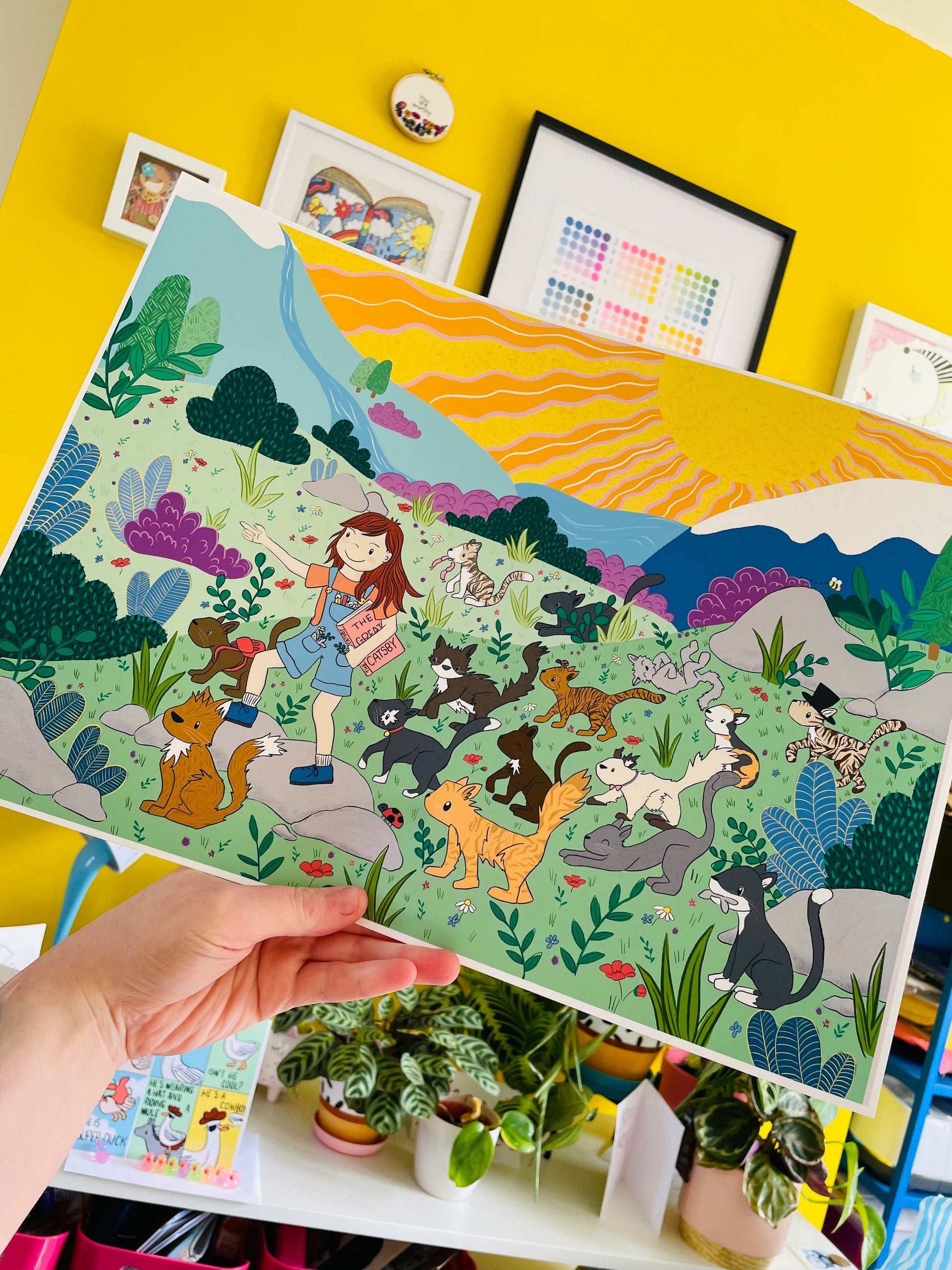 Colourful illustration of a girl and a group of cats adventuring through a cololourful wild landscape