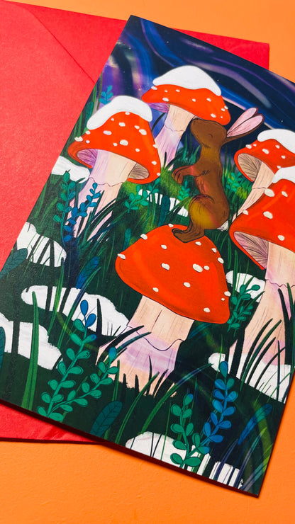 Illustrated greeting card or a tiny bunny on a landscape of magical winter, snowy toadstools