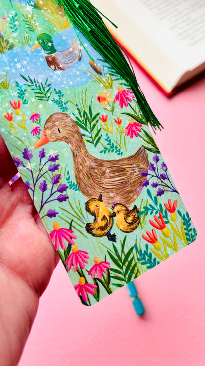 close up image of a holographic bookmark with a mallard illustration 