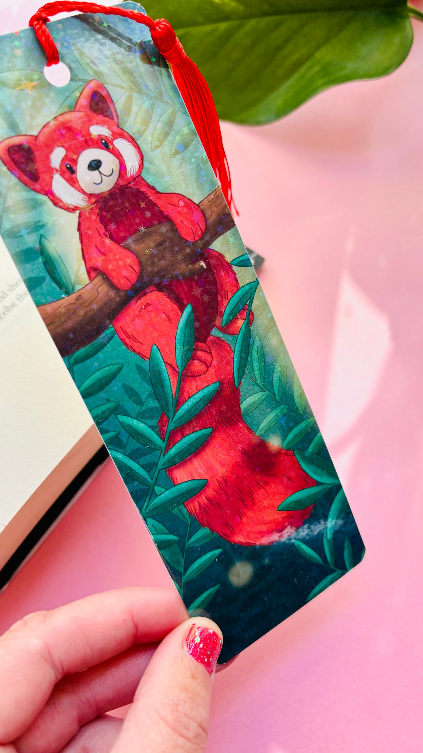 Hand-illustrated red panda gift holographic bookmark with rainbow holographic finish and green tassel – double-sided, eco-friendly 300gsm cardstock, handmade UK gift for book lovers.