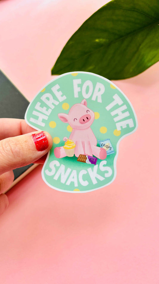 Hand-illustrated “Here for the Snacks” pig vinyl sticker, waterproof and handmade in the UK – cute design with a pig surrounded by snacks for laptops, water bottles, and journals.
