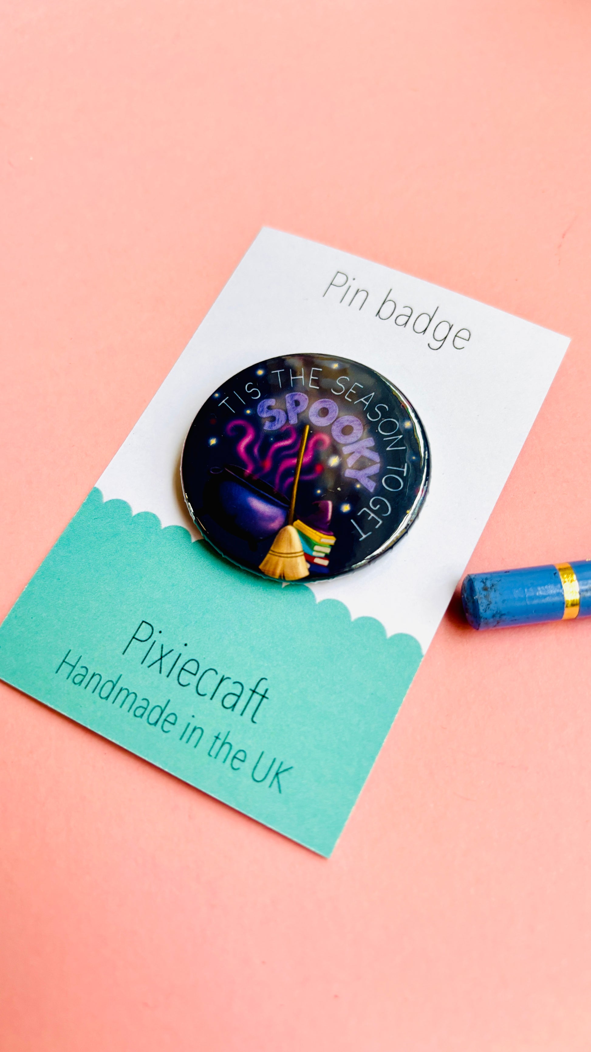 Cute hand-drawn Halloween badge or magnet featuring “Tis the Season to Get Spooky” text above a magical cauldron and broom, ideal for spooky fans.