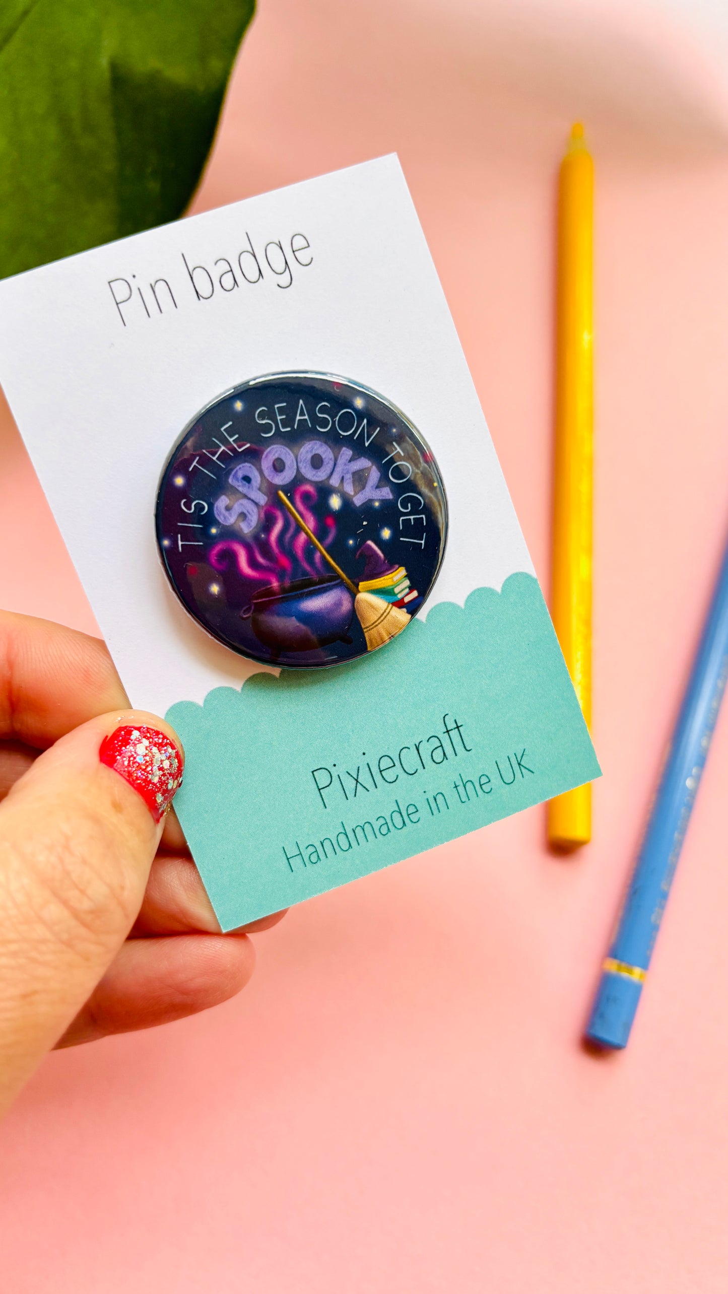Cute hand-drawn Halloween badge or magnet featuring “Tis the Season to Get Spooky” text above a magical cauldron and broom, ideal for spooky fans.