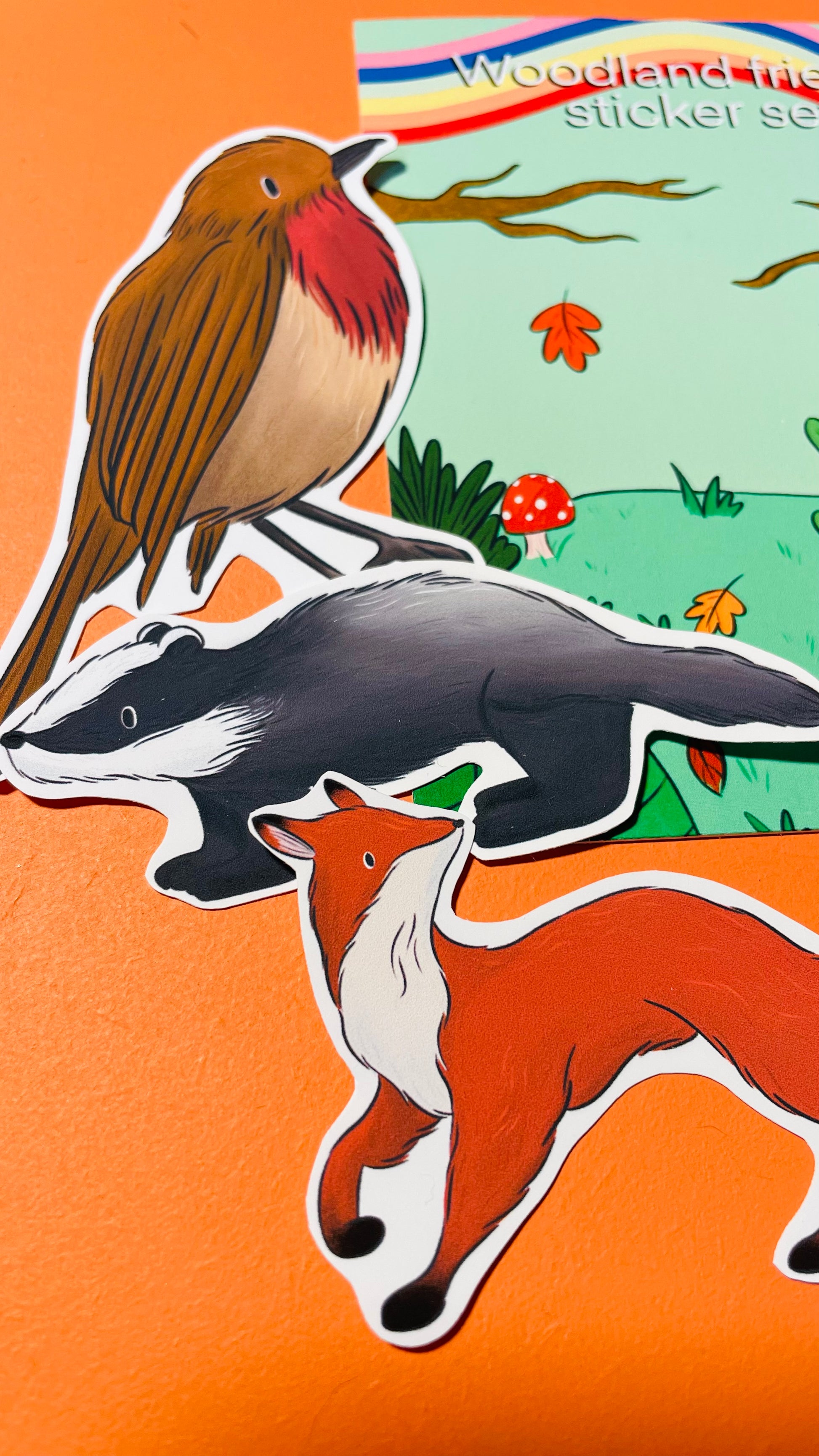 A close up image of some illustrated stickers including a badger, fox and robin