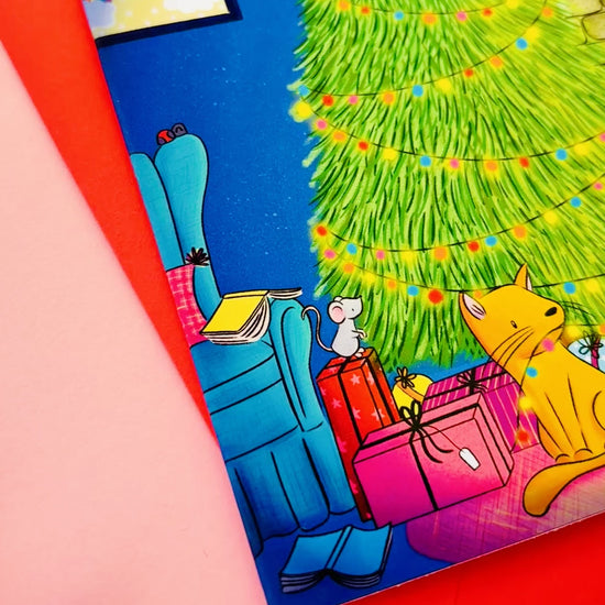 Handmade Christmas card with two playful cats by a decorated tree and fireplace, perfect festive greeting for cat lovers.