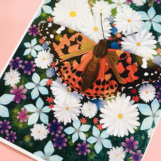 Colourful nature art print of a painted lady butterfly resting in a field of wildflowers. This beautiful illustration is perfect for lovers of nature, botanical illustration, wildflowers and cottagecore aesthetics. Illustrated and printed in the uk onto archival matte art paper and signed by the artist. 
